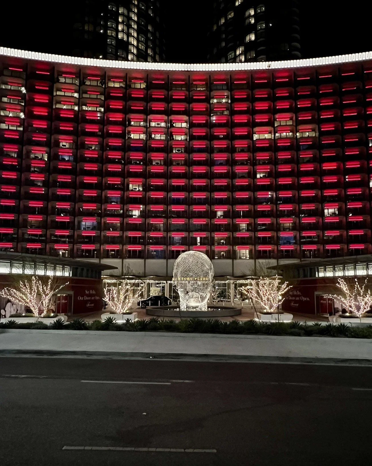 Fairmont Century Plaza at night with red-wrapped entry pavilions