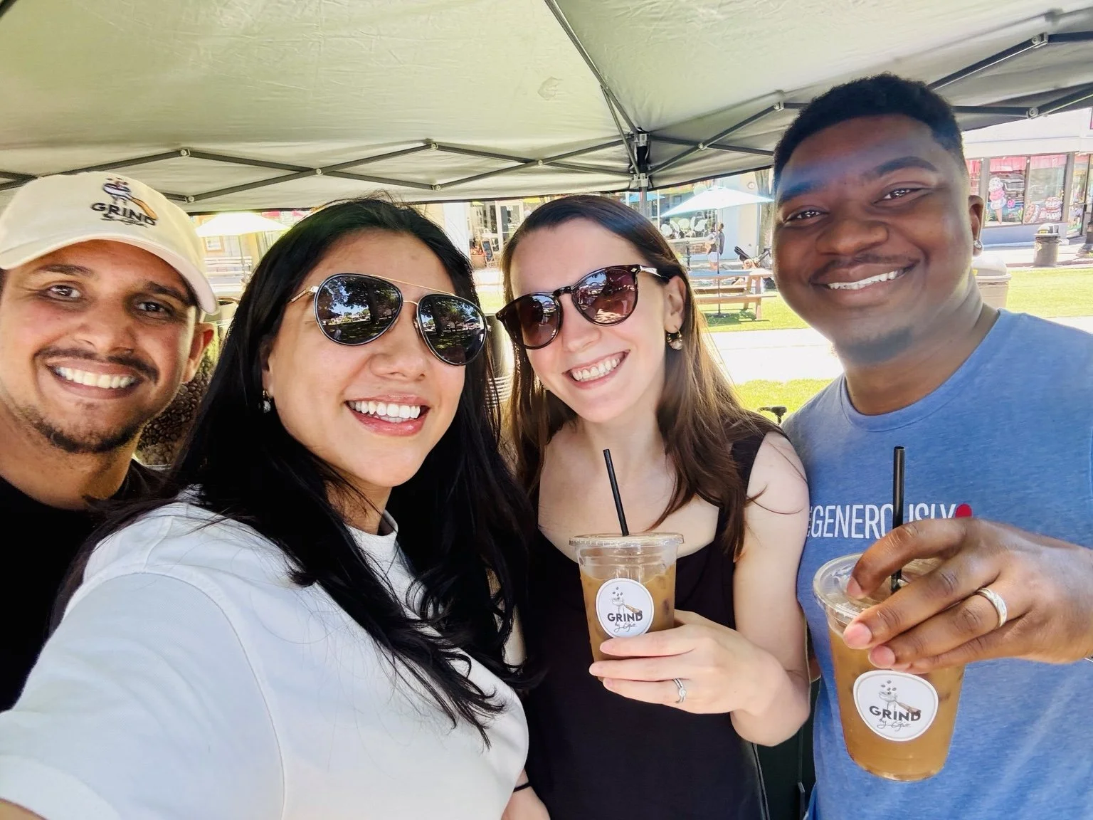 Flor with guests enjoying Grind by Gio iced coffee at a community event