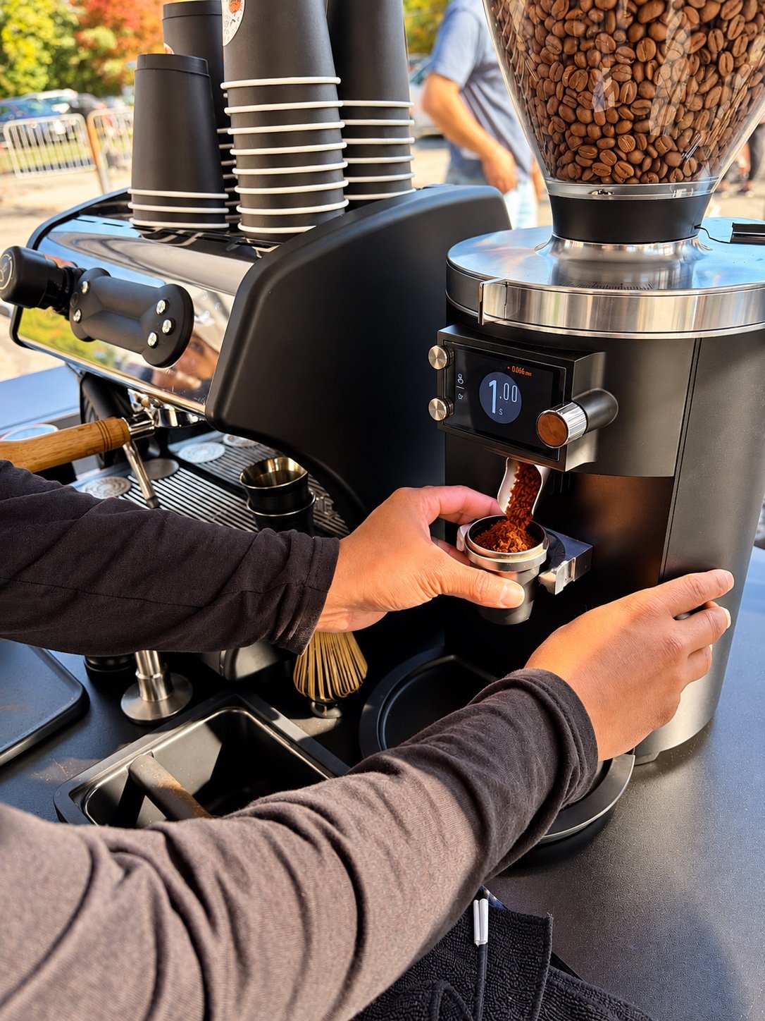 Barista preparing espresso at the Grind by Gio coffee cart