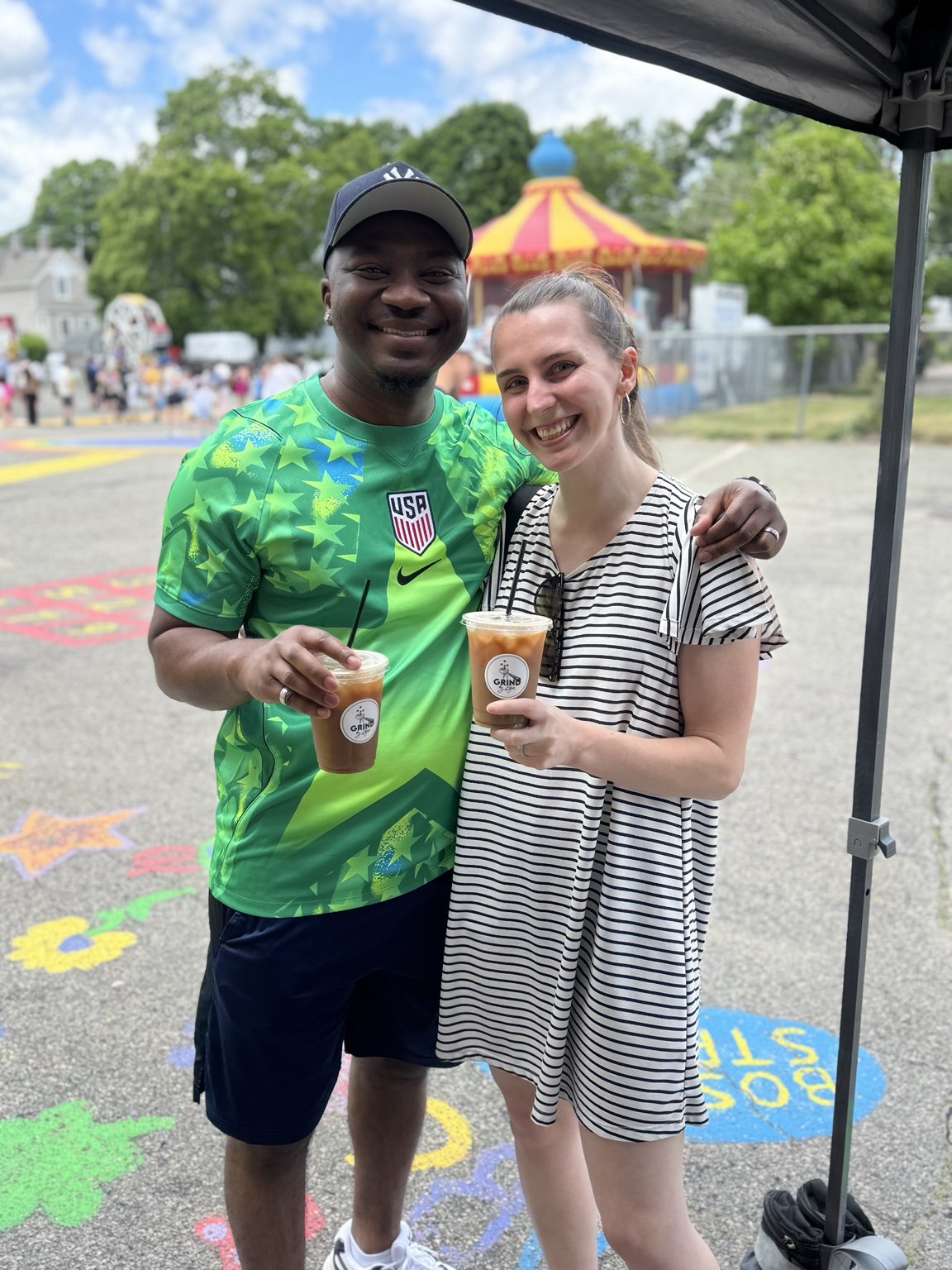 Guests with Grind by Gio iced coffee at an outdoor community event