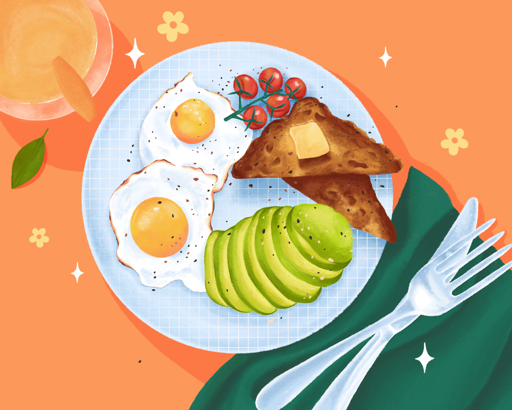 A plate of two sunny-side-up eggs, sliced avocado, cherry tomatoes on a vine, and two toasted bread triangles with butter, on a blue checkered plate, with a fork on a green napkin, set on a peach-colored table with a glass of juice, leaves, and small flowers.