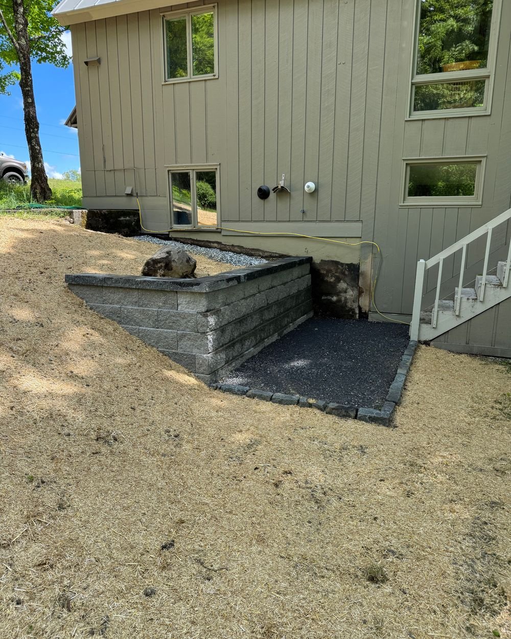 Built to last 💪🧱 Replacing a failing wood wall with engineered block, proper drainage, and a french drain means this hillside is ready to handle the weather and protect the property for the long haul. Good prep and drainage make all the difference.