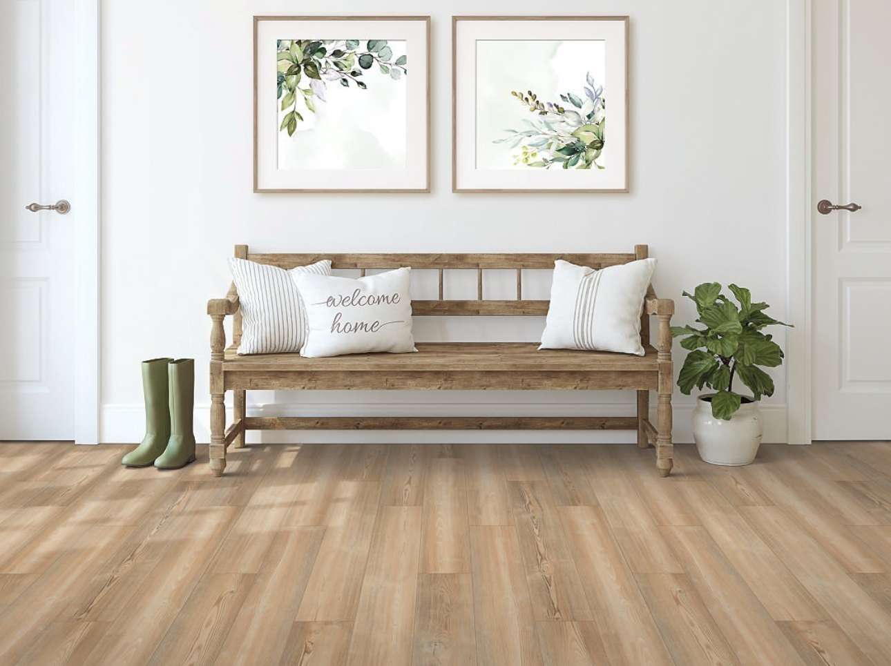 Rustic wooden entryway bench with welcome pillow, framed botanical artwork, green rain boots, and potted plant