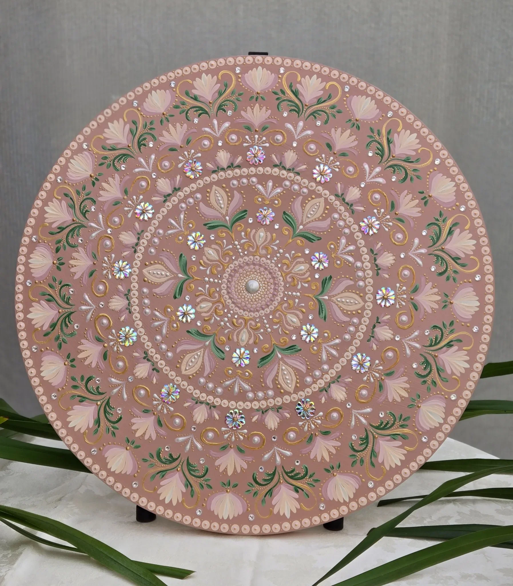 Hand-painted mandala wall art on a 24-inch round birch wood canvas featuring blush-pink petals and a dusty rose background.