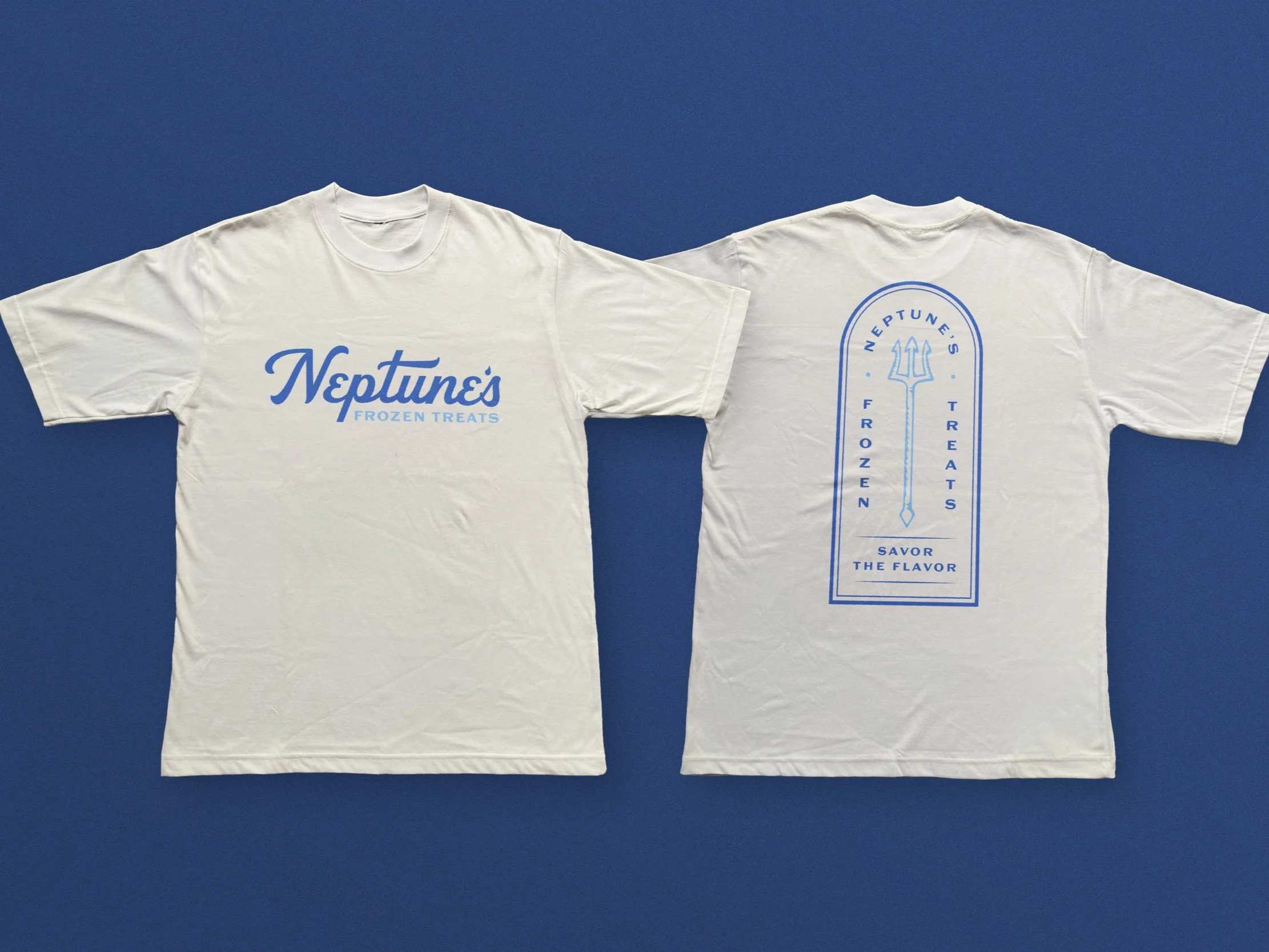 Two white T-shirts displayed on a blue background, one front view and one back view. The front T-shirt features a blue logo with the text 'Neptune's' and 'Frozen Treats'. The back T-shirt has a blue design inspired by a trident with the text 'Neptune