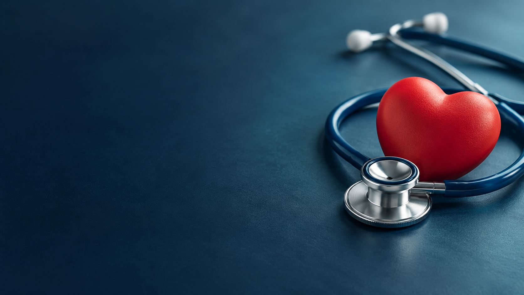 Red heart and stethoscope on a dark blue background