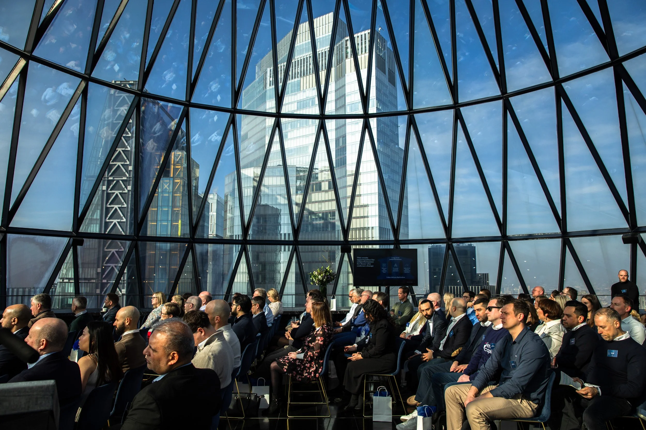 Overhead view of guests networking at a corporate event inside The Gherkin, overlooking the City of London.