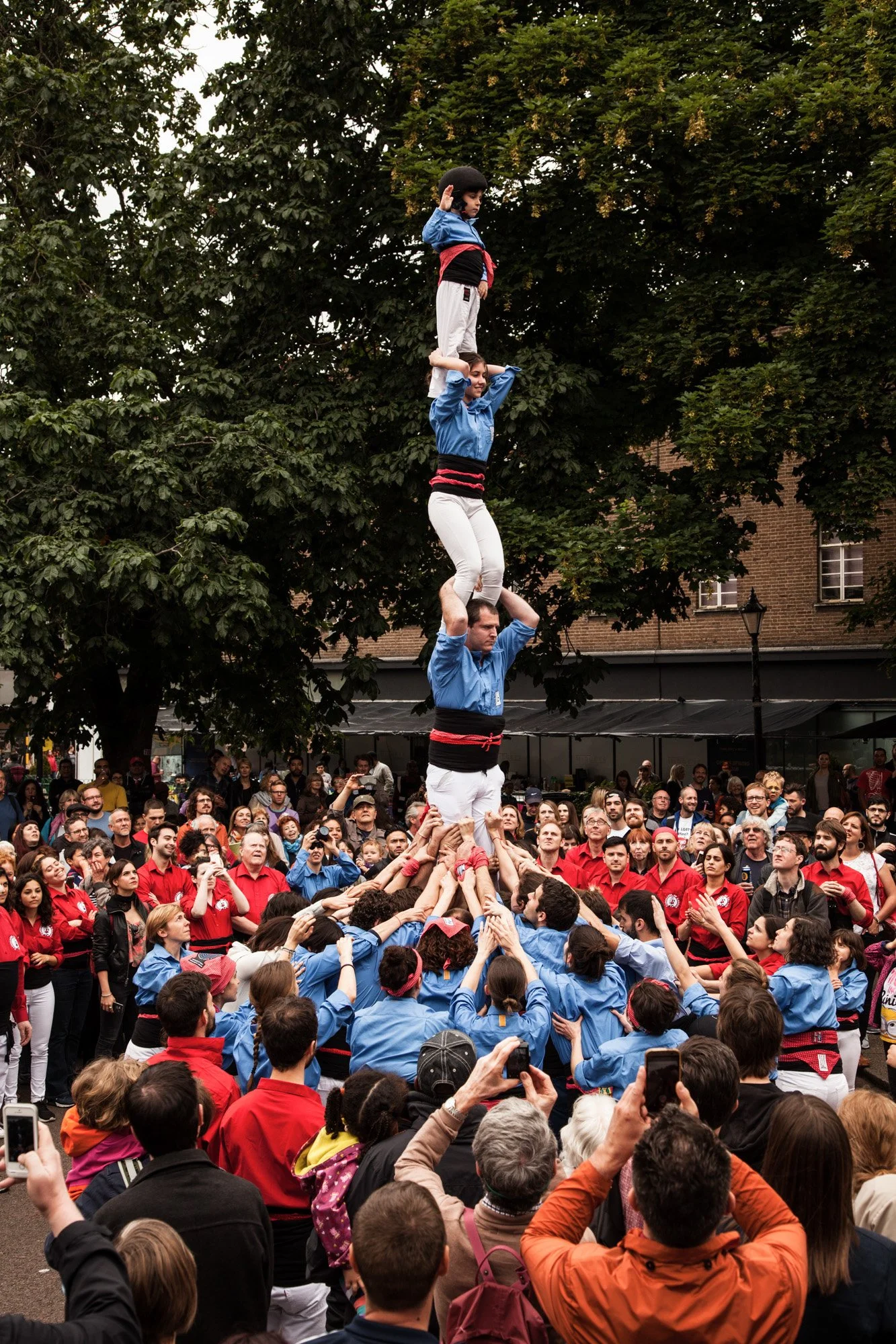 Performers building a human tower above a crowd at a LatinoLife event.