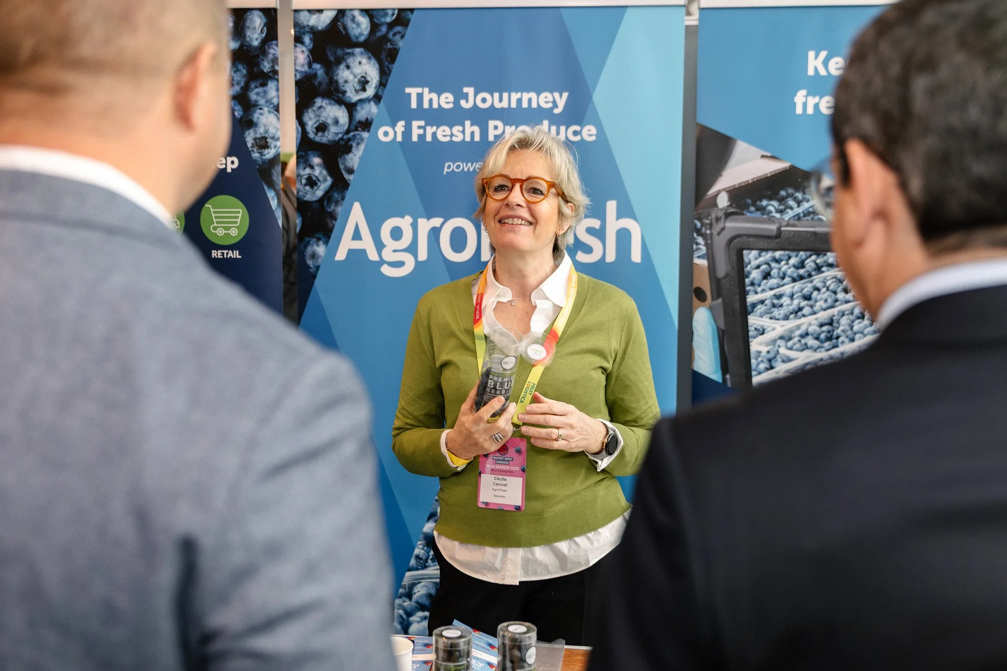 An AgroFresh exhibitor talking with visitors at Berry Congress.