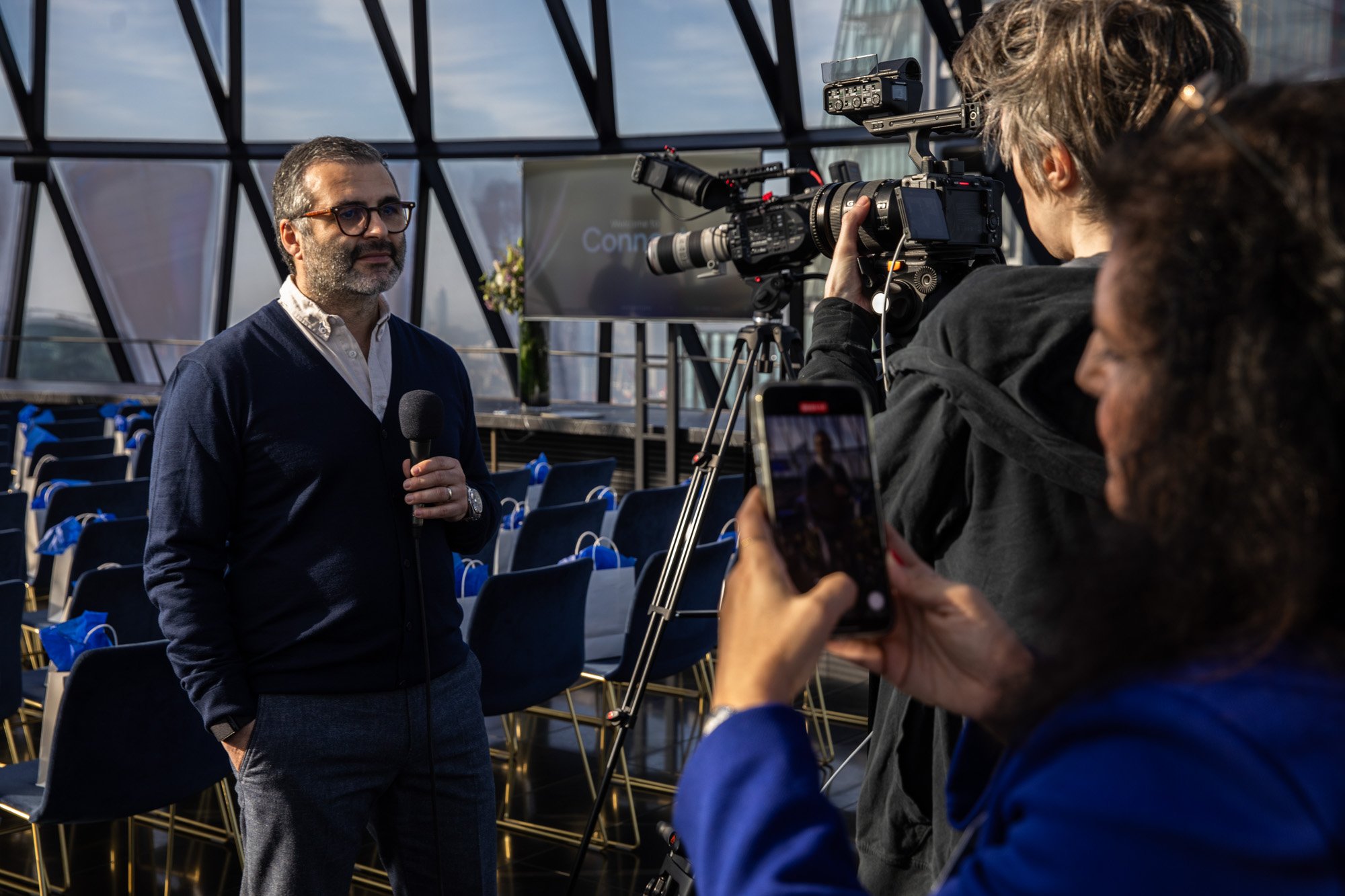 Professional video interview being filmed at the Connect+ corporate event at The Gherkin, London, with a camera operator recording a guest.