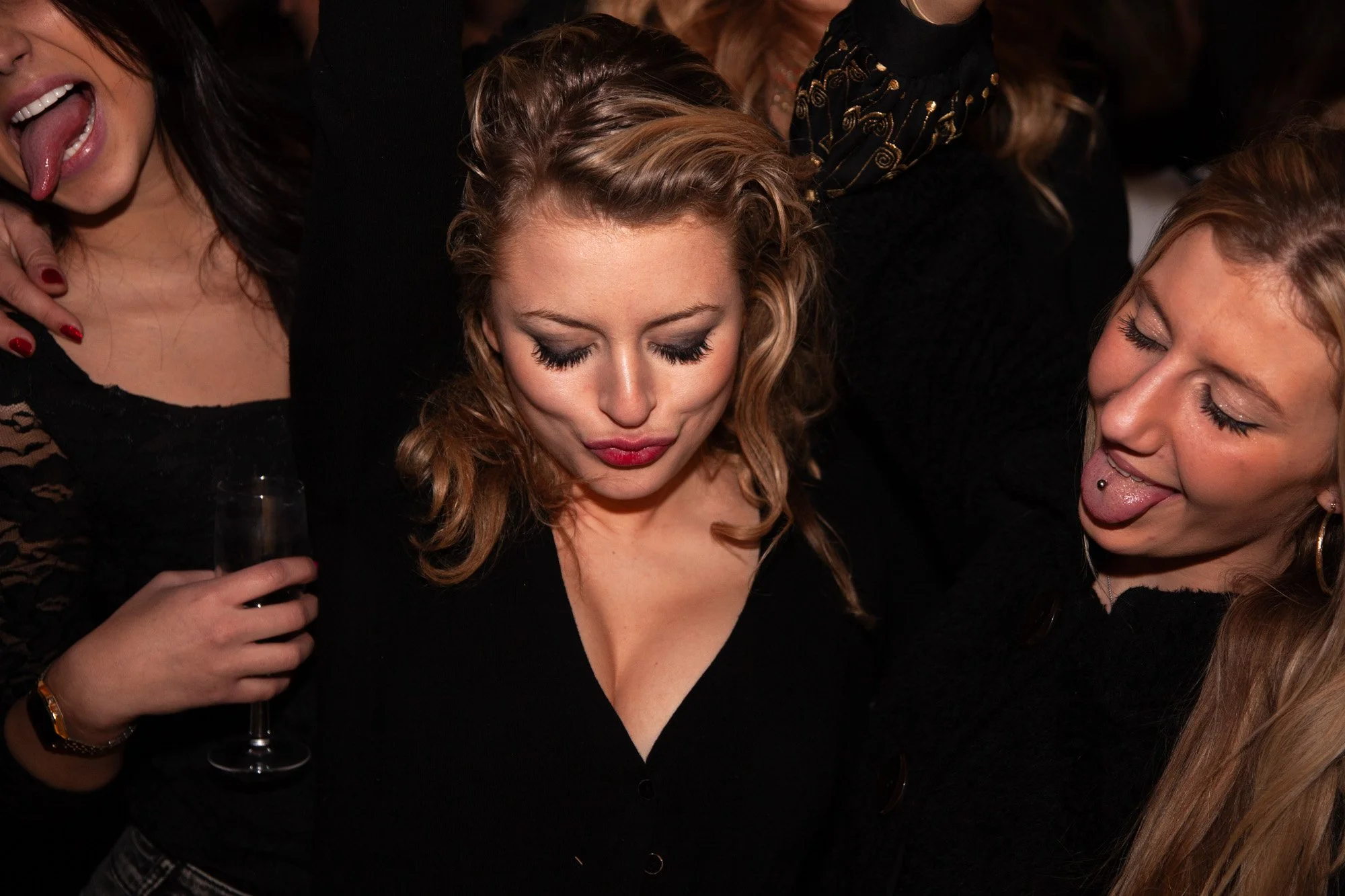 Three guests pulling playful faces together at an awards reception.