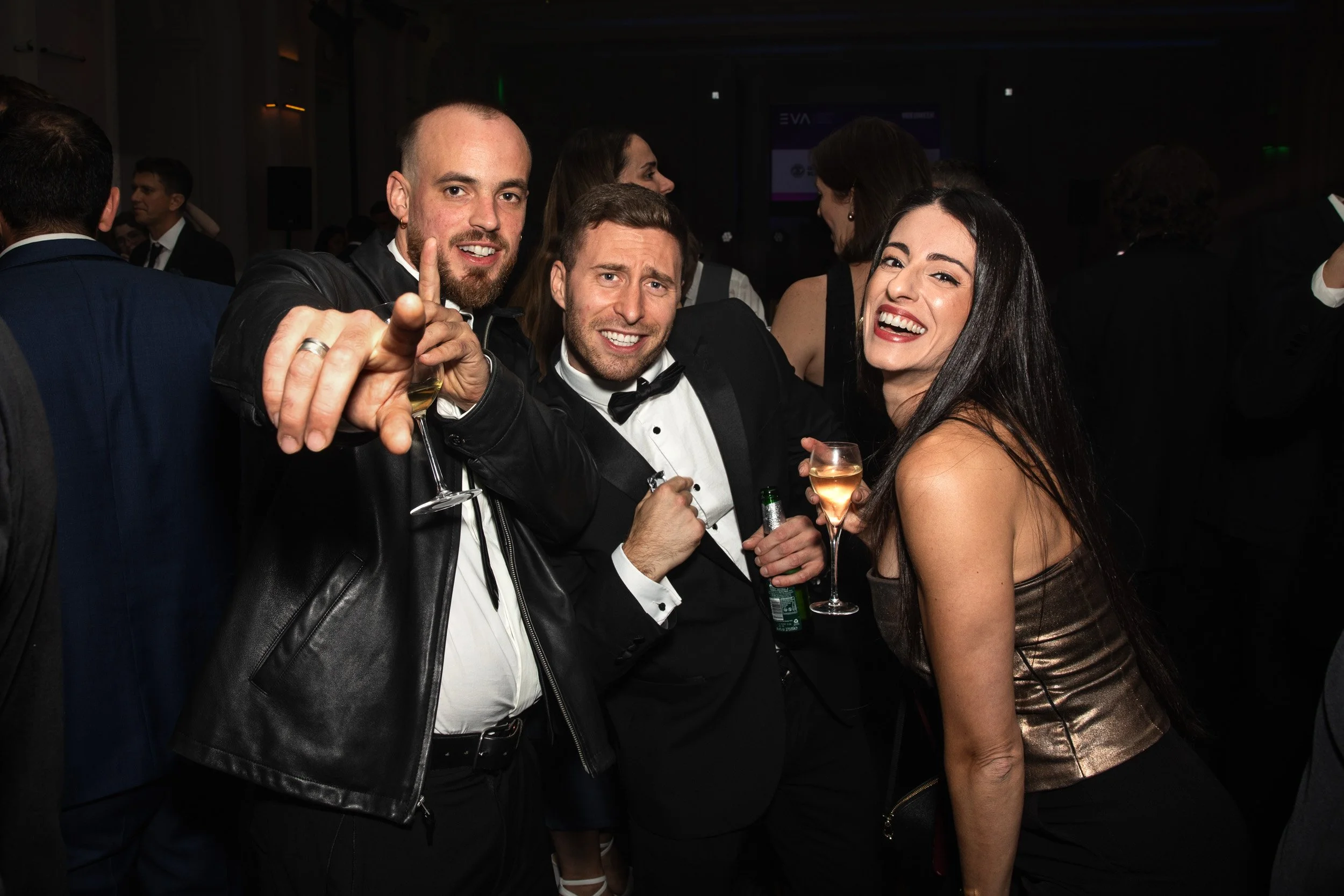 Three guests smiling and posing playfully for the camera at the European Video Awards, London.