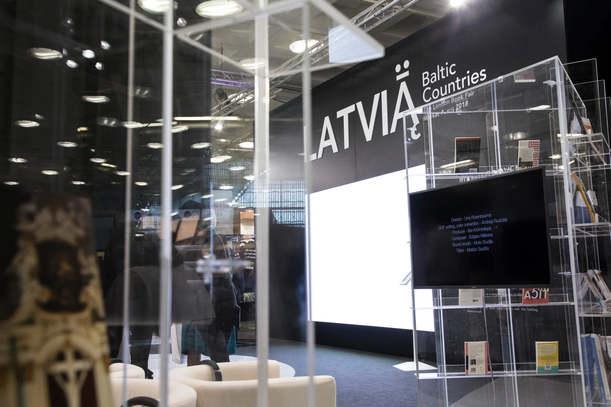The Latvia exhibition stand displaying books and information at a book fair.