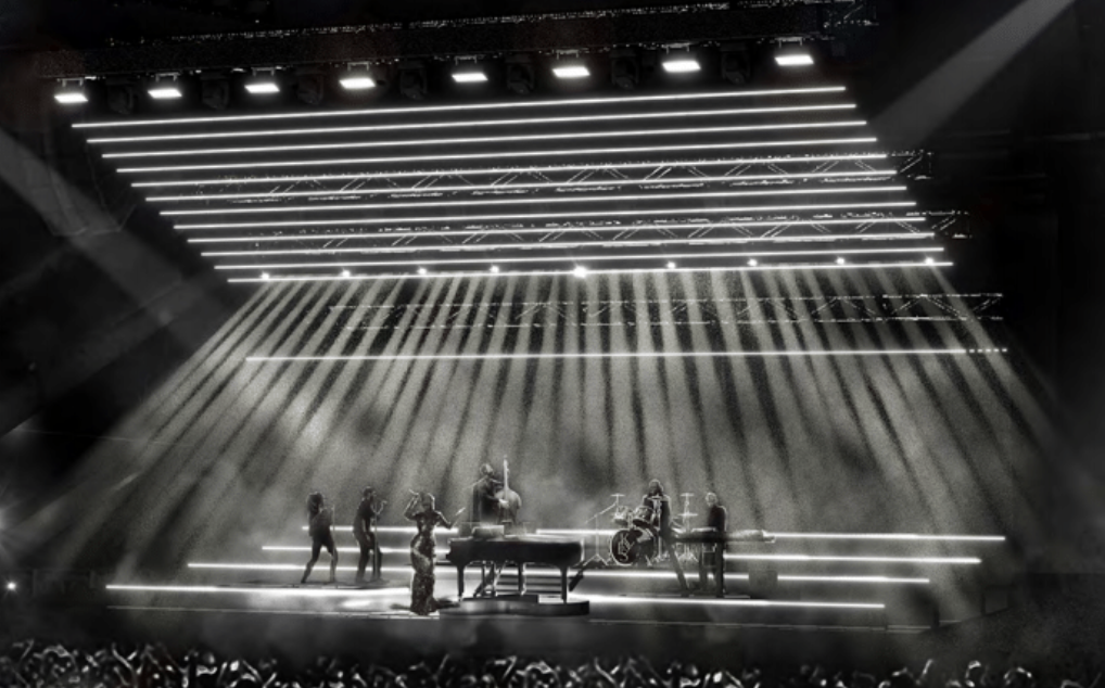 A band performing live on stage with dramatic lighting and fog effects, including a keyboard player, a drummer, a guitarist, and singers.