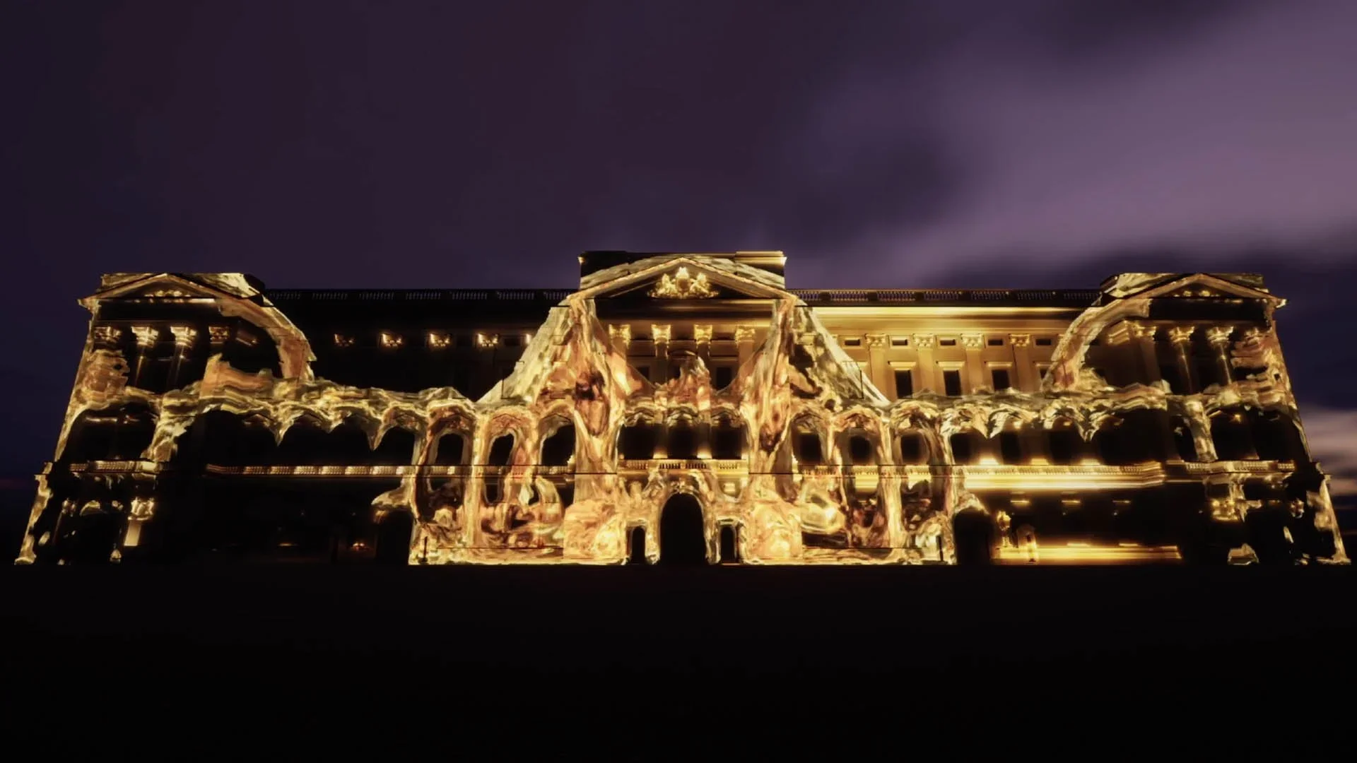 Building illuminated with colorful light projection during nighttime.
