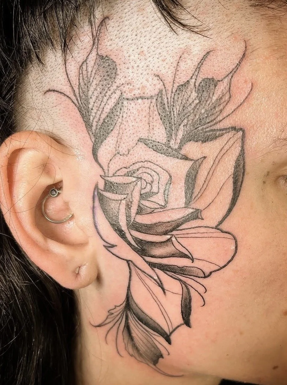 Neo Traditional black and grey rose tattoo on a face by Altered Tattoo Co