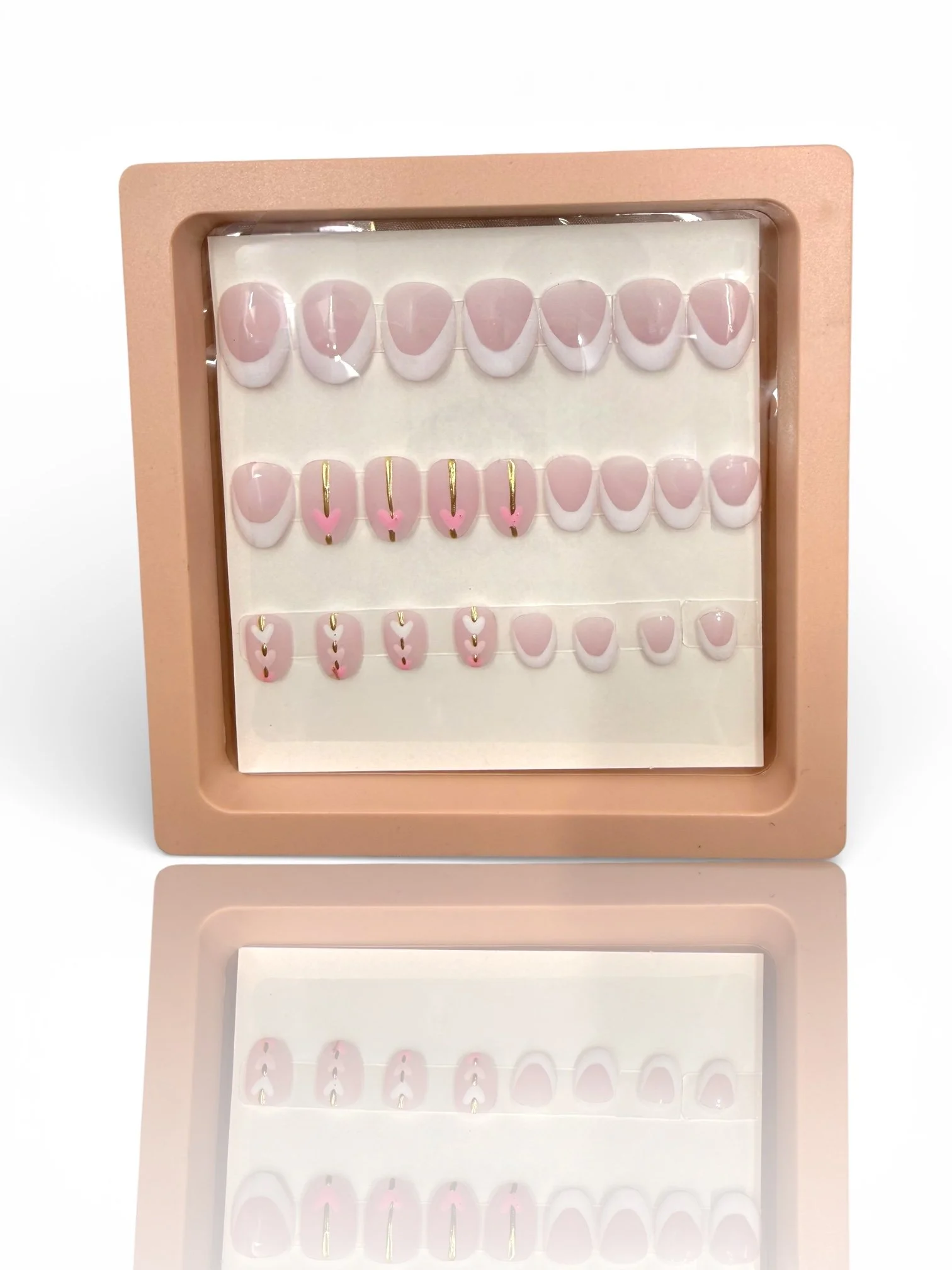kids matte Pink stiletto press-on nails with nude pink bases, French tips, gold accents, and delicate white heart designs.