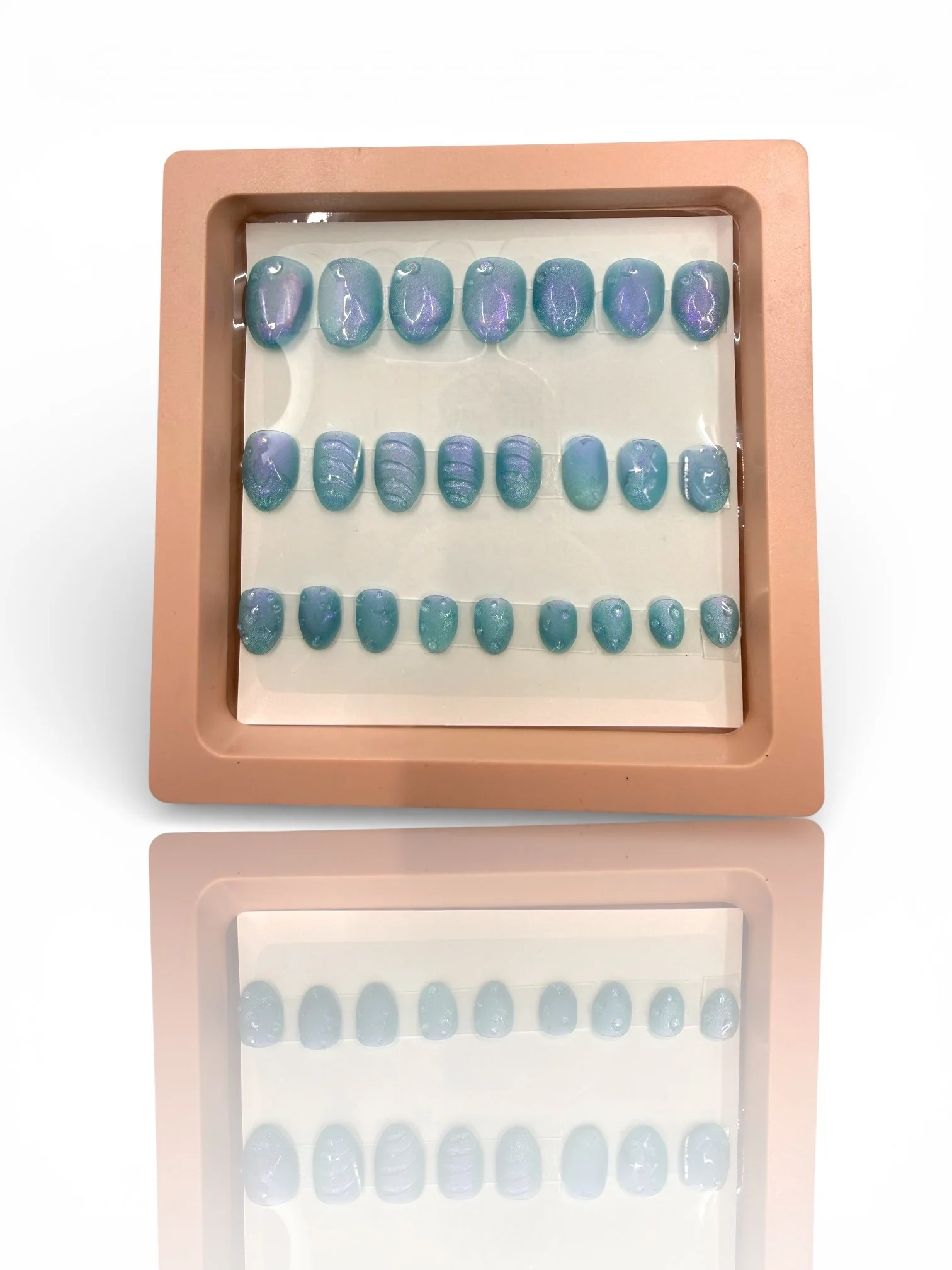 kids Shimmering ocean blue almond-shaped press-on nails with mermaid-inspired scales, textured wave details, and an iridescent finish.