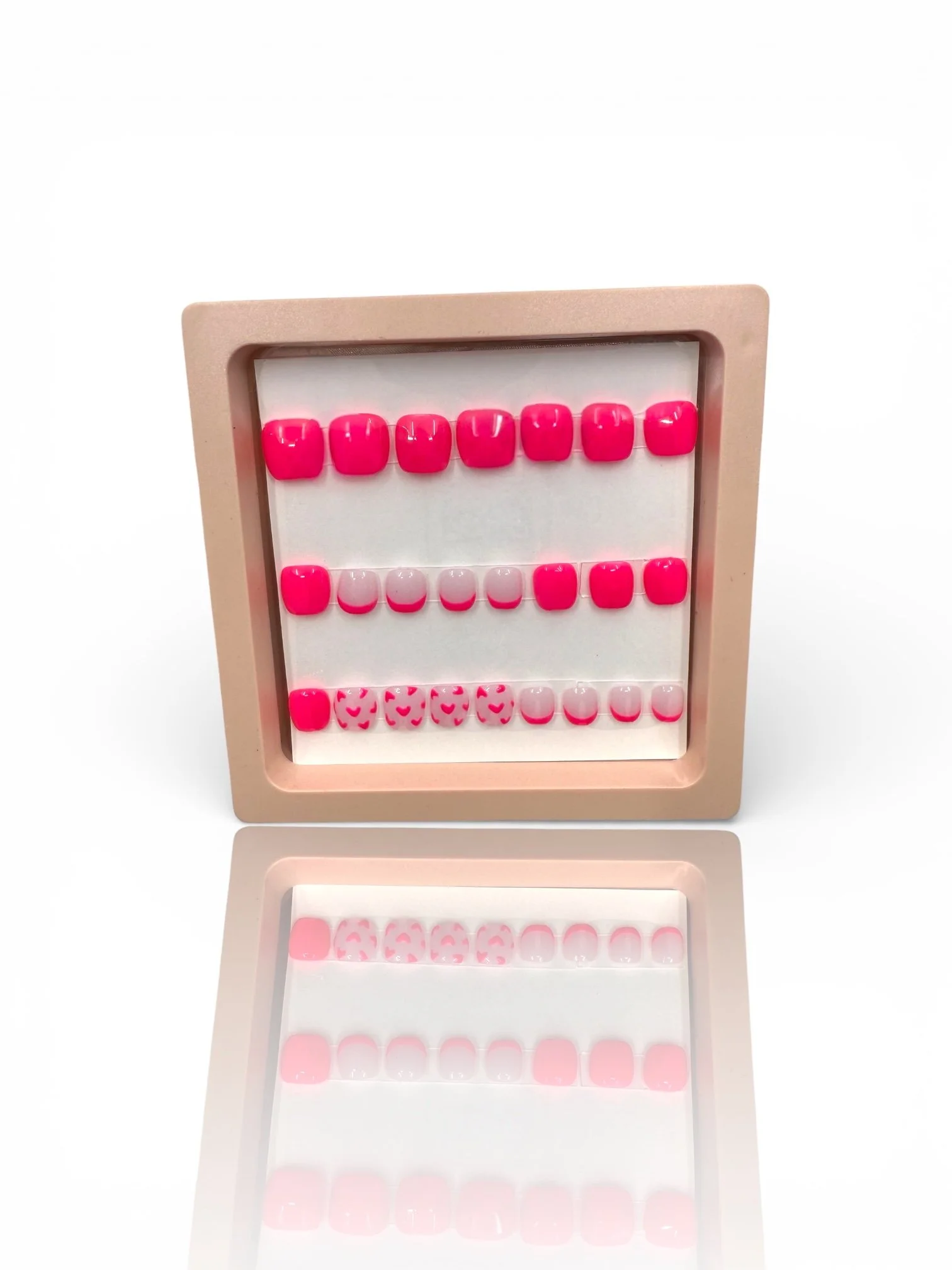 kids Glossy bright pink square press-on nails with light pink French tips and adorable pink heart designs.