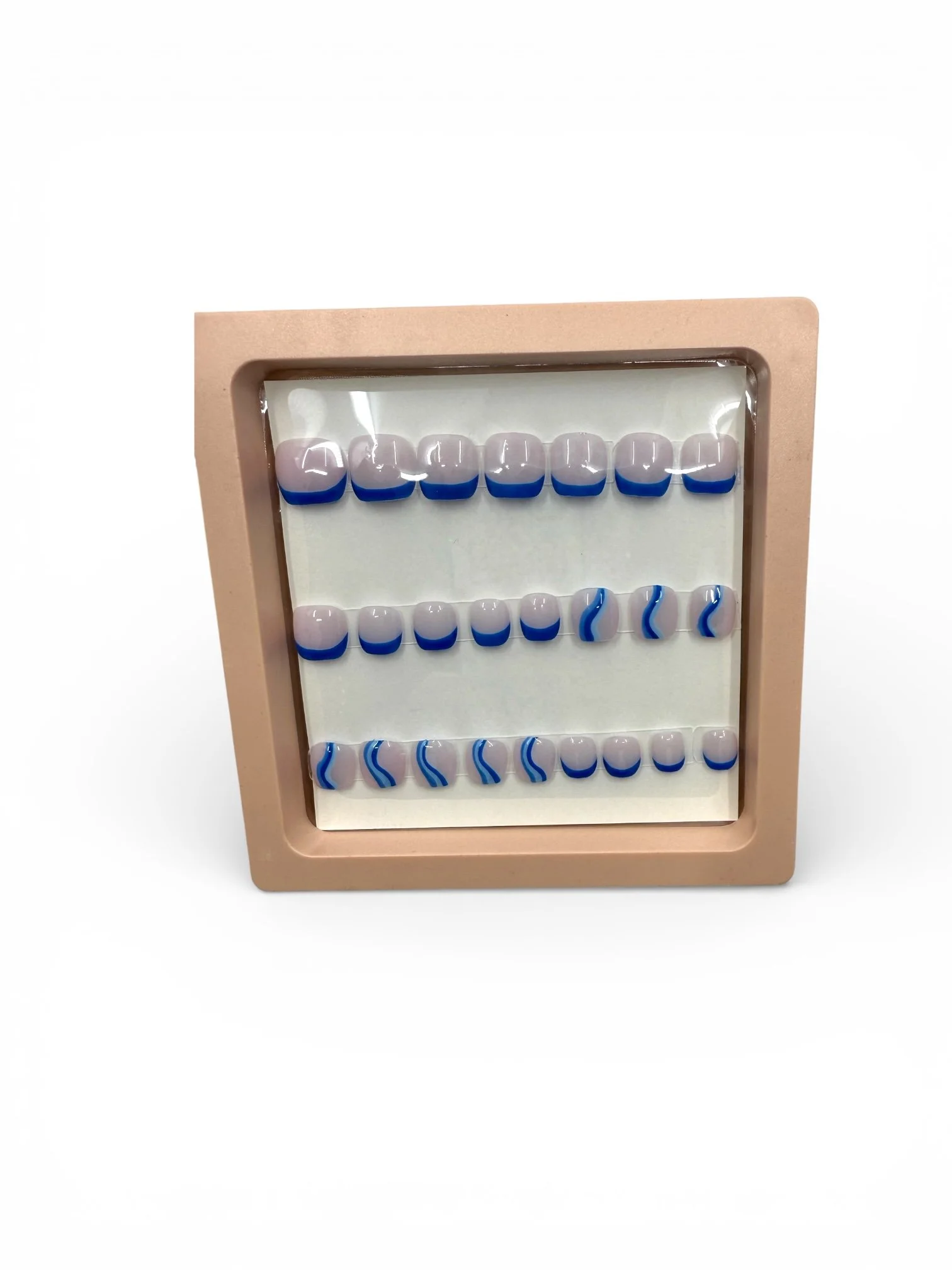 kids Glossy nude square press-on nails with royal blue French tips and blue and white wavy nail art designs.