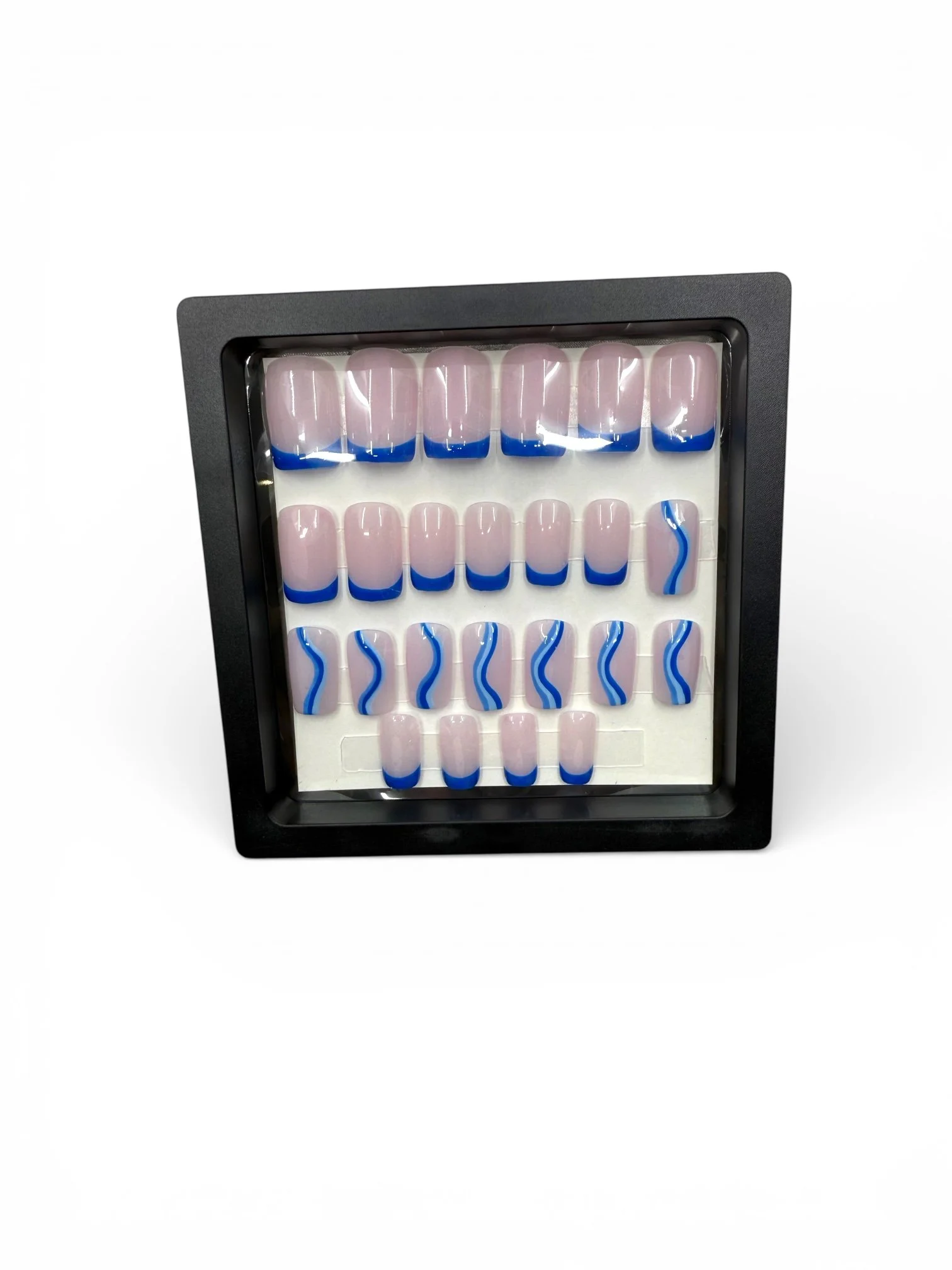 long Glossy nude square press-on nails with royal blue French tips and blue and white wavy nail art designs.