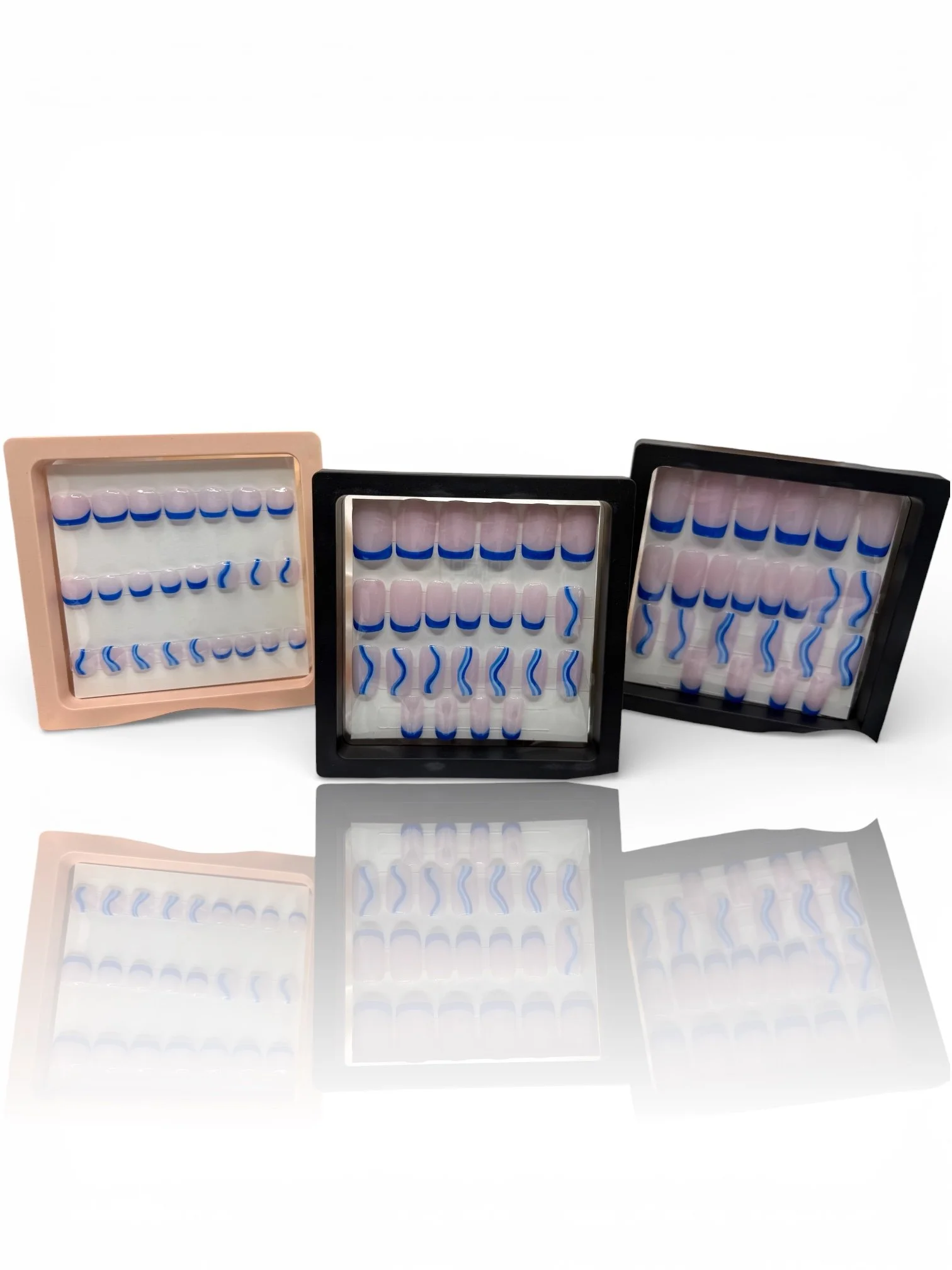 long Glossy nude square press-on nails with royal blue French tips and blue and white wavy nail art designs.
