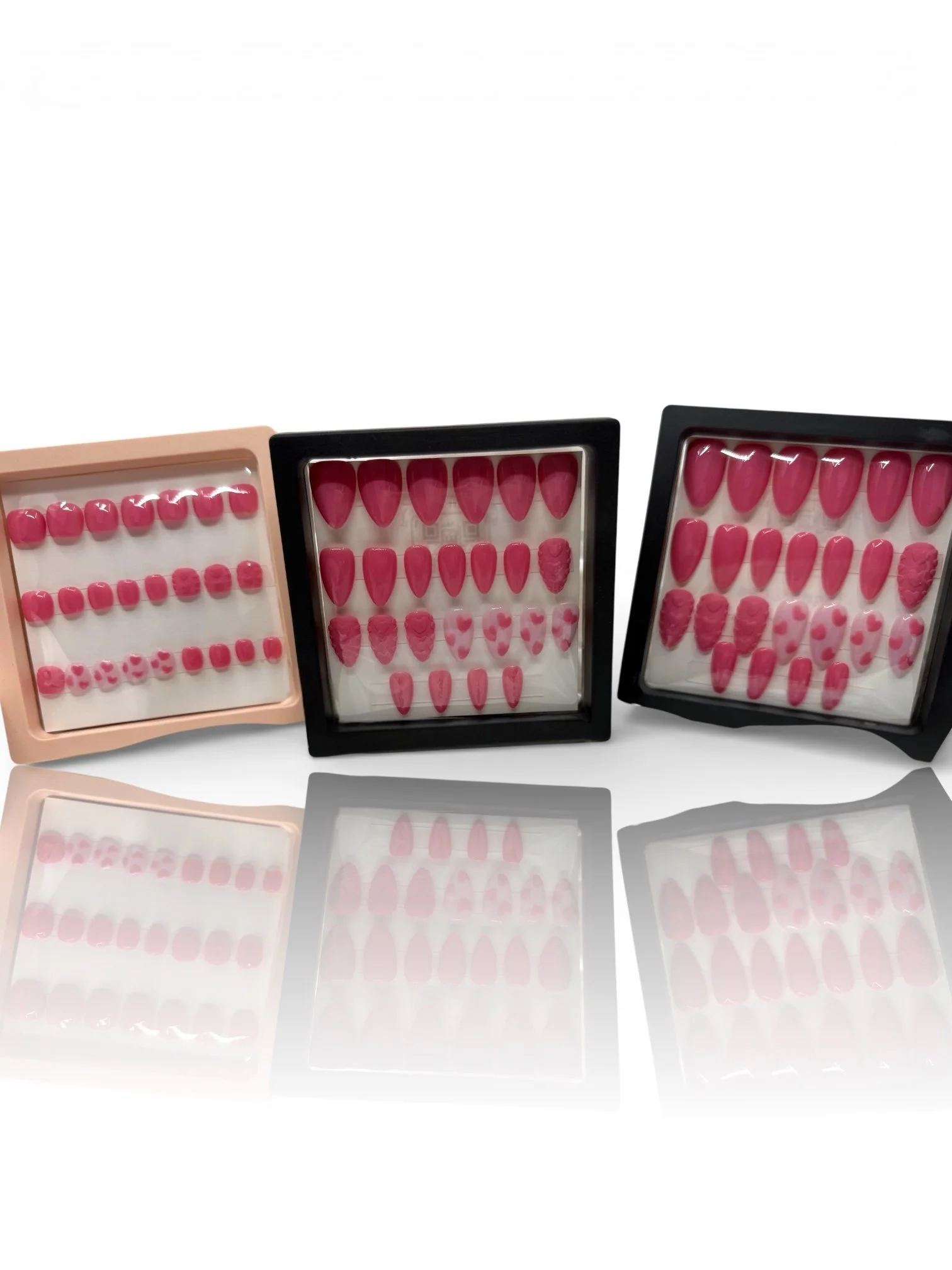 long Pink almond-shaped press-on nails with 3D sweater-knit heart designs, raised textures, and pink heart accents.
