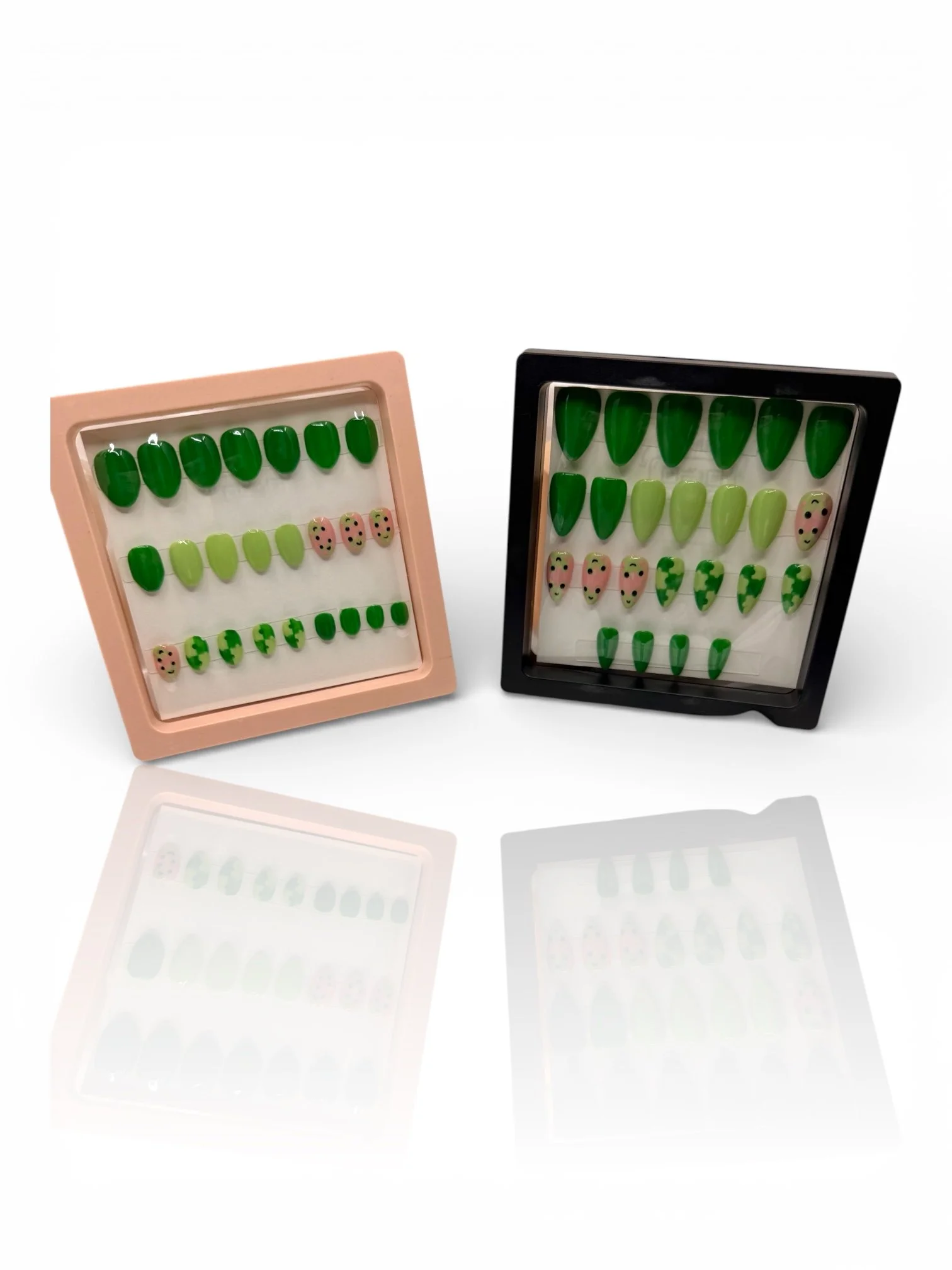short Green almond-shaped press-on nails with cute pink frog faces, lily pad designs, and glossy light and dark green accents.