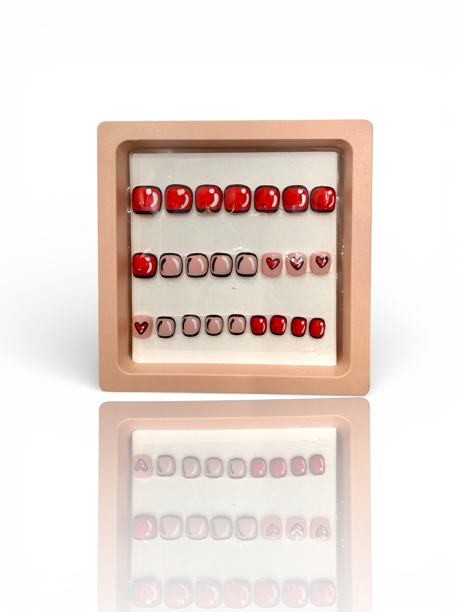 kids matte red and pink square press-on nails with black outlines, white shine accents, and cute red heart designs.