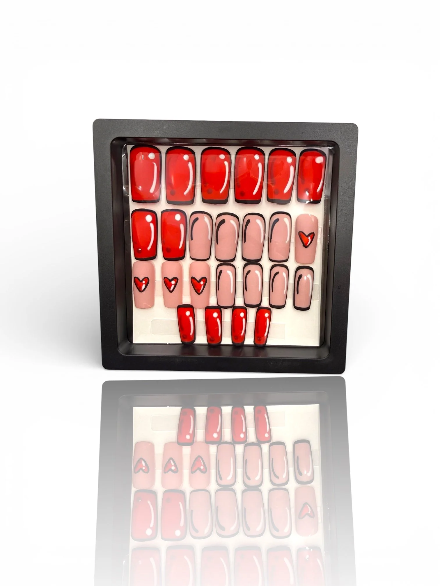 long matte red and pink square press-on nails with black outlines, white shine accents, and cute red heart designs.