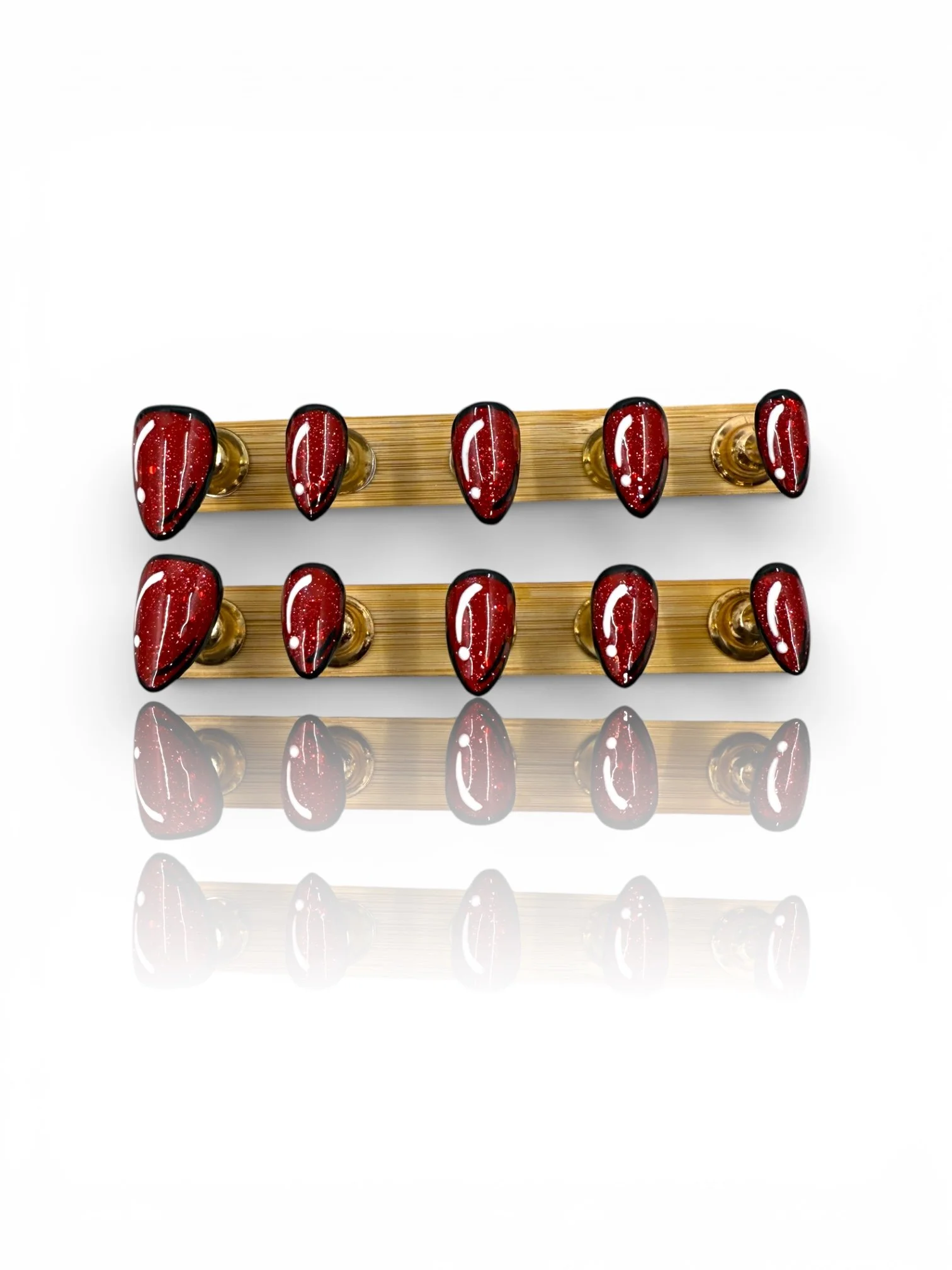 Sparkling red glitter almond press-on nails with glossy finish and black accents.