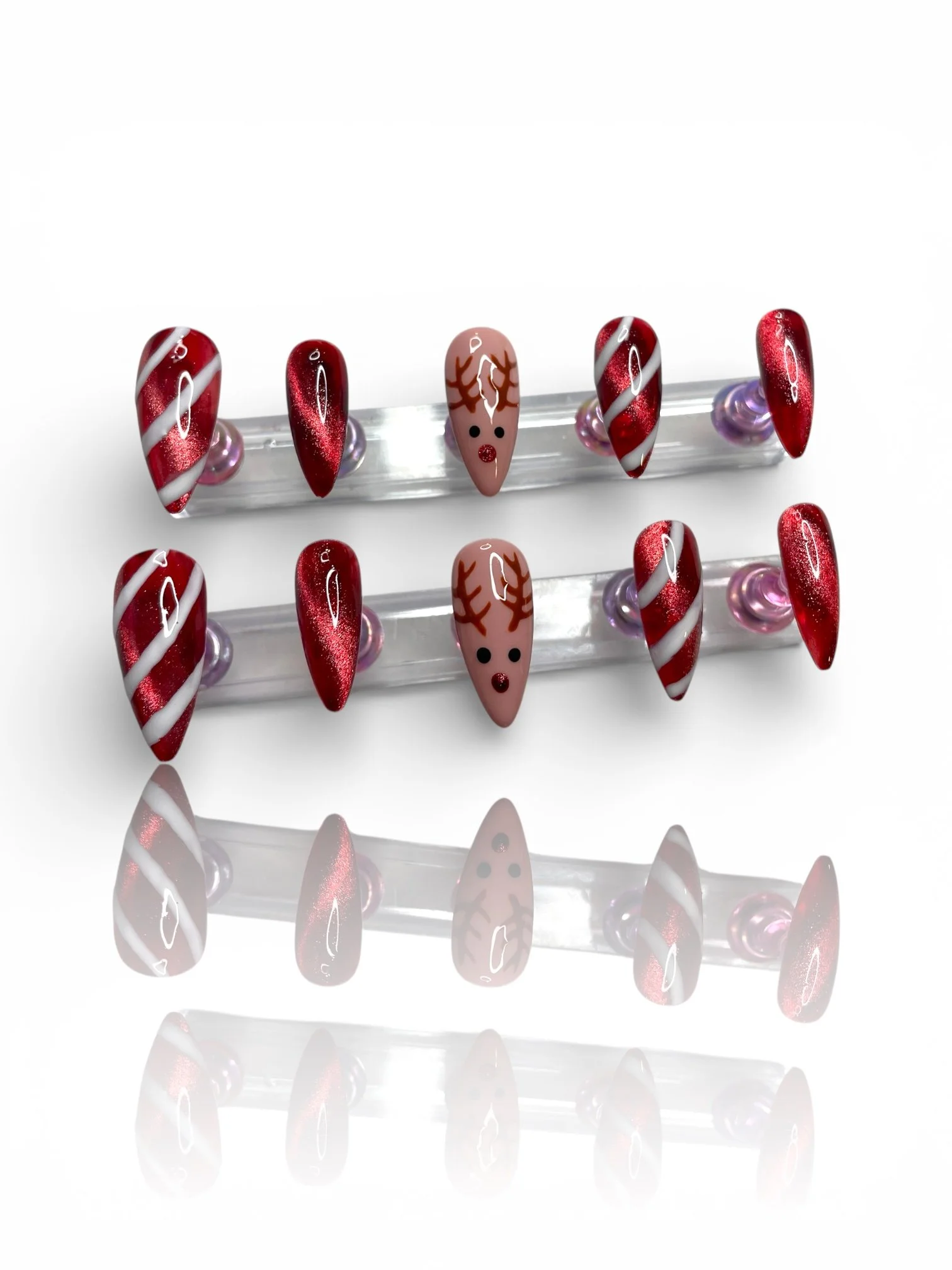 medium Christmas stiletto press-on nails with glittery burgundy red, white candy cane stripes, and cute reindeer designs.