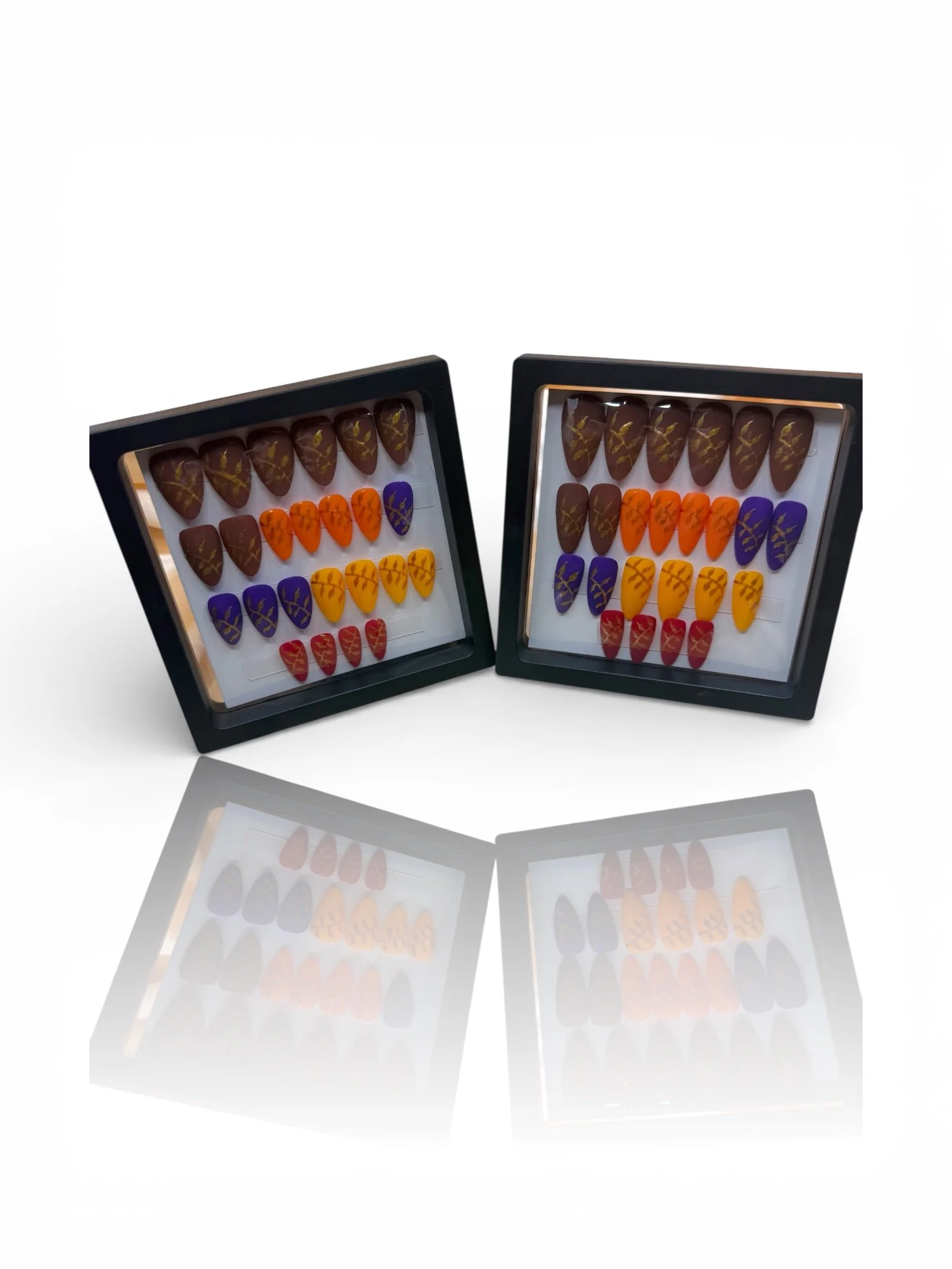 short Almond press-on nails with autumn colors and metallic gold leaf designs.