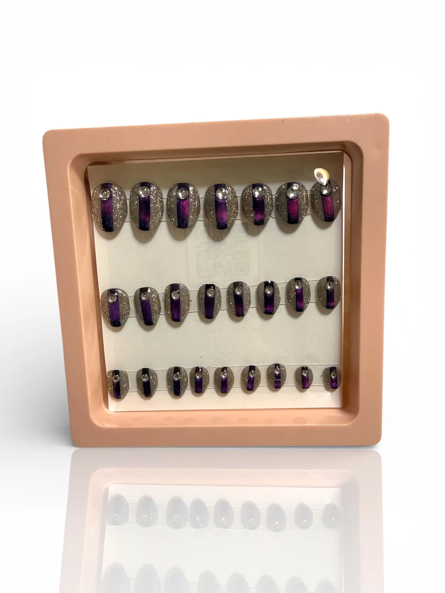 Purple almond cat eye press-on nails with silver glitter and rhinestone accents. kids