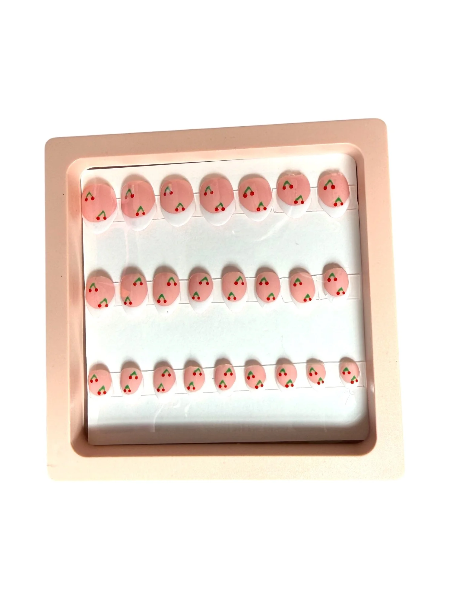 kids Pink almond-shaped press-on nails with white French tips and hand-painted red cherry designs with green stems.