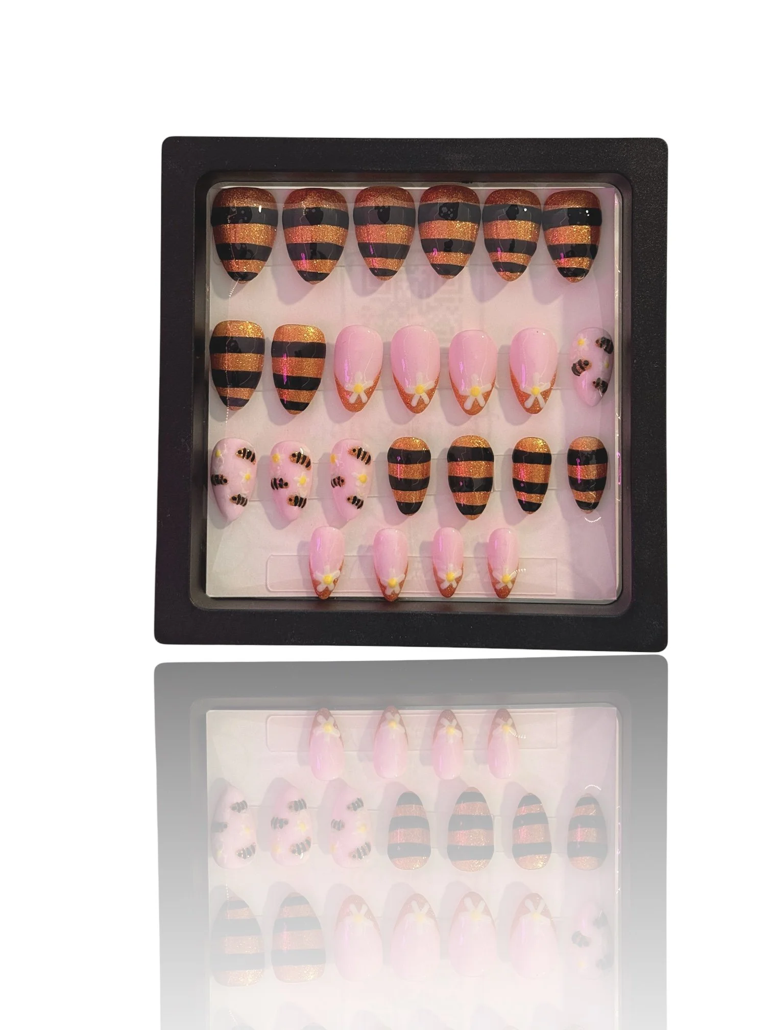 medium Glow-in-the-dark almond press-on nails with glittery orange and black bee stripes, pink bases, and cute bumblebee designs.