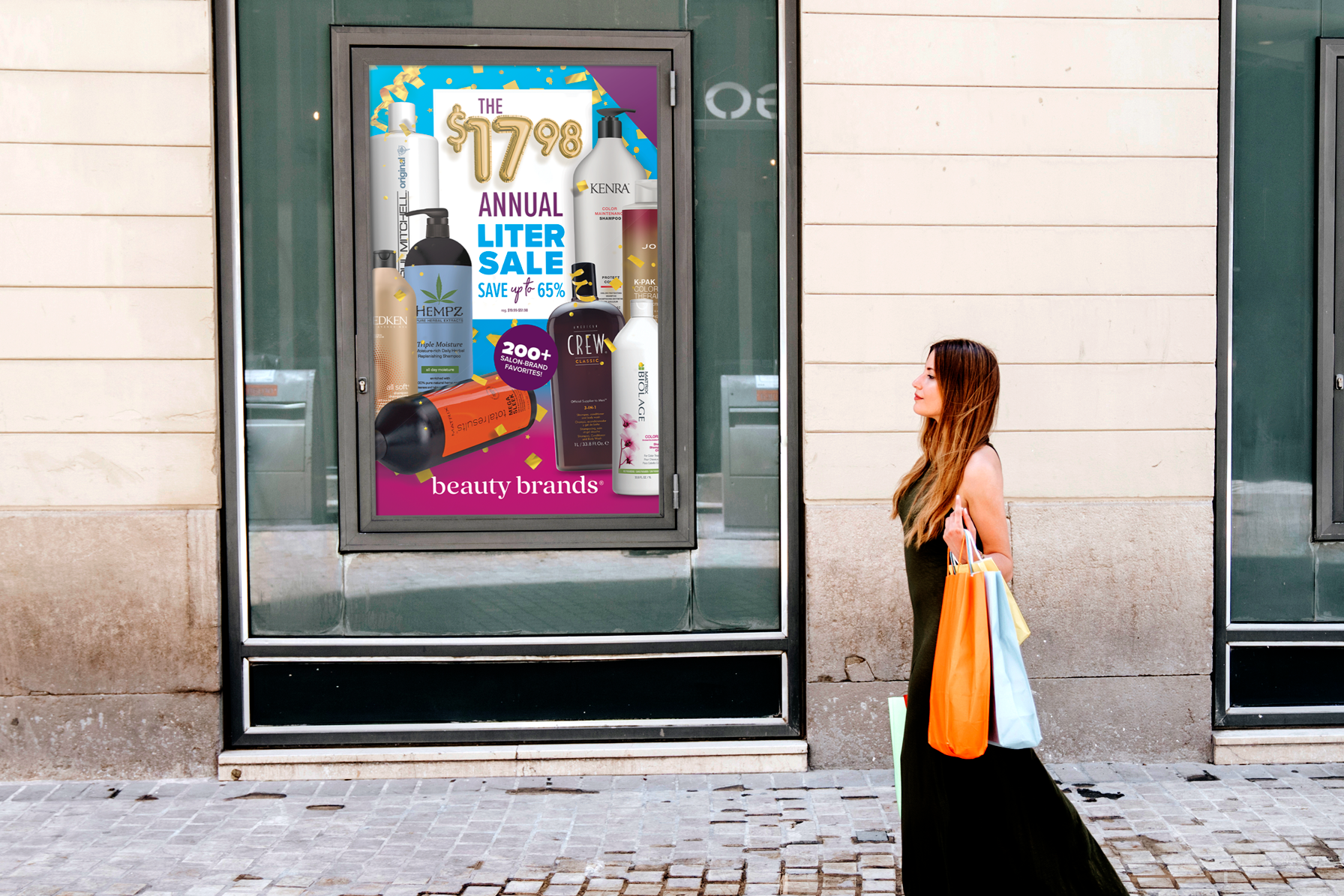 A woman walking past a store window with an advertisement for a beauty products sale. The woman has long hair, is wearing a green dress, and is carrying several colorful shopping bags.