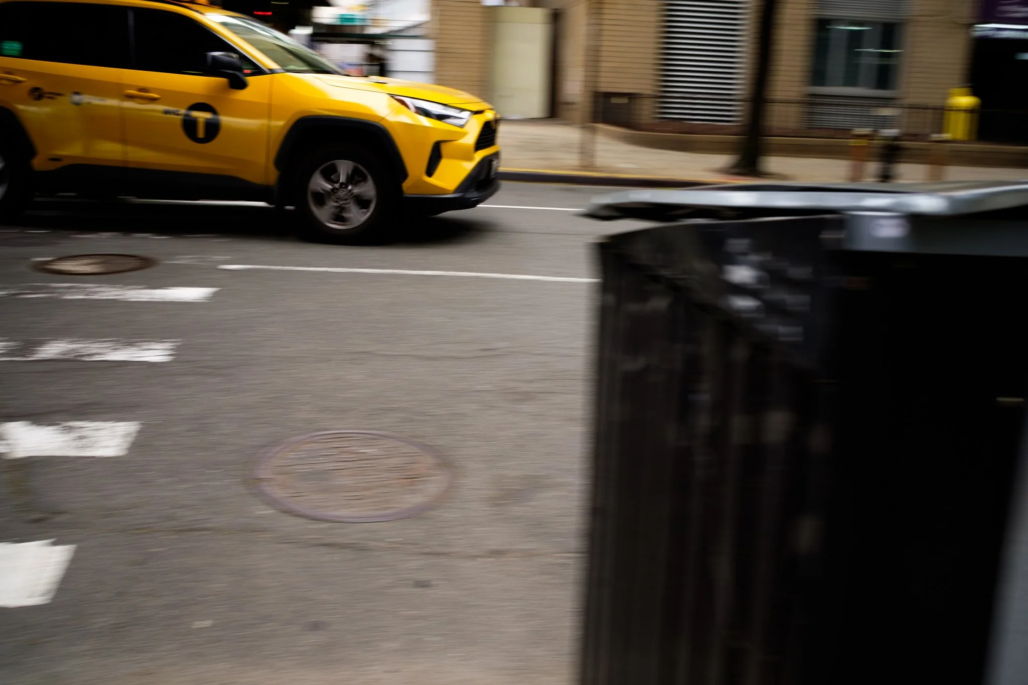 Yellow taxi driving on a city street