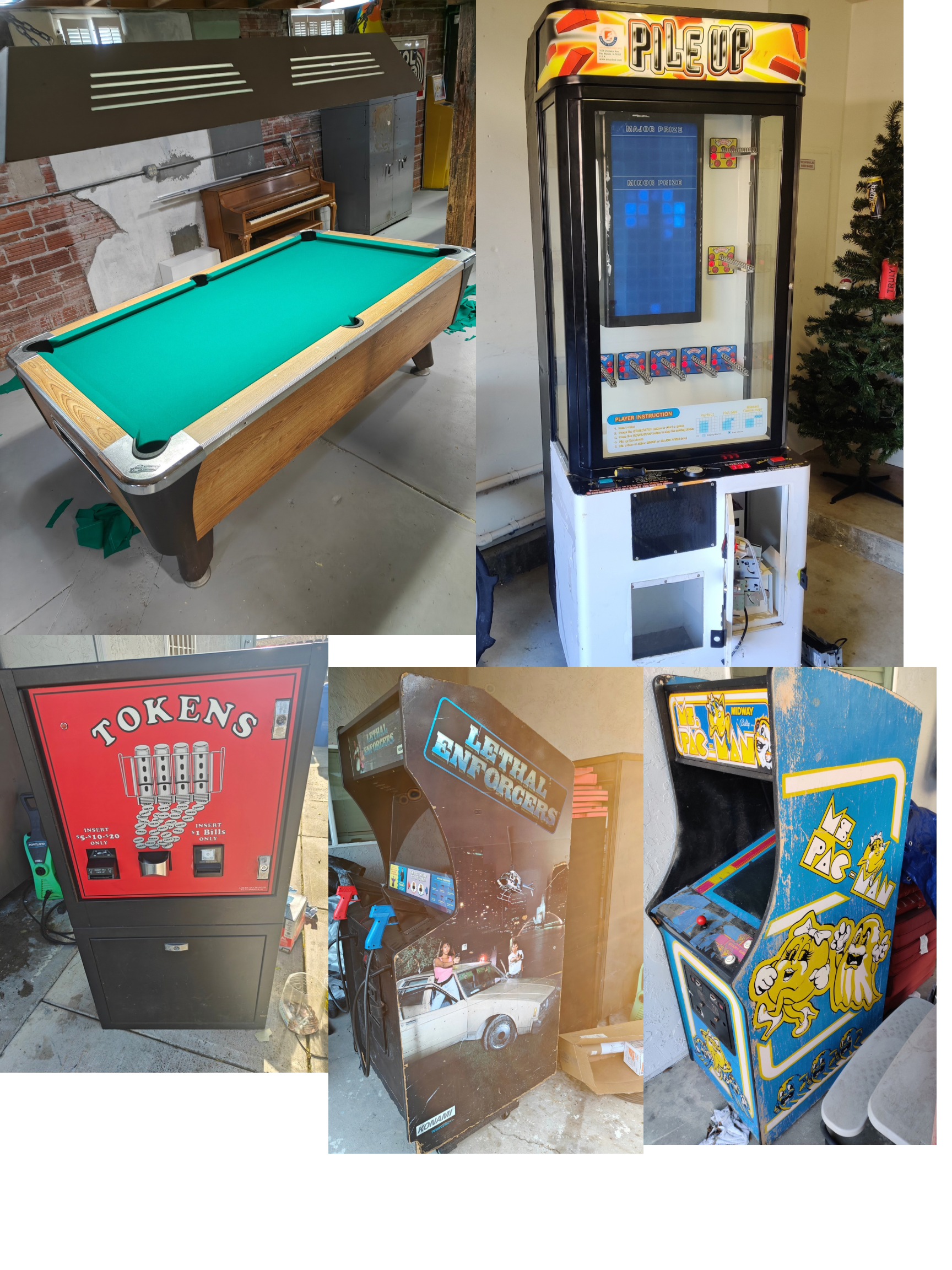 A collection of vintage arcade games, including a pool table and crane games, with a Christmas tree and other items in an indoor setting.