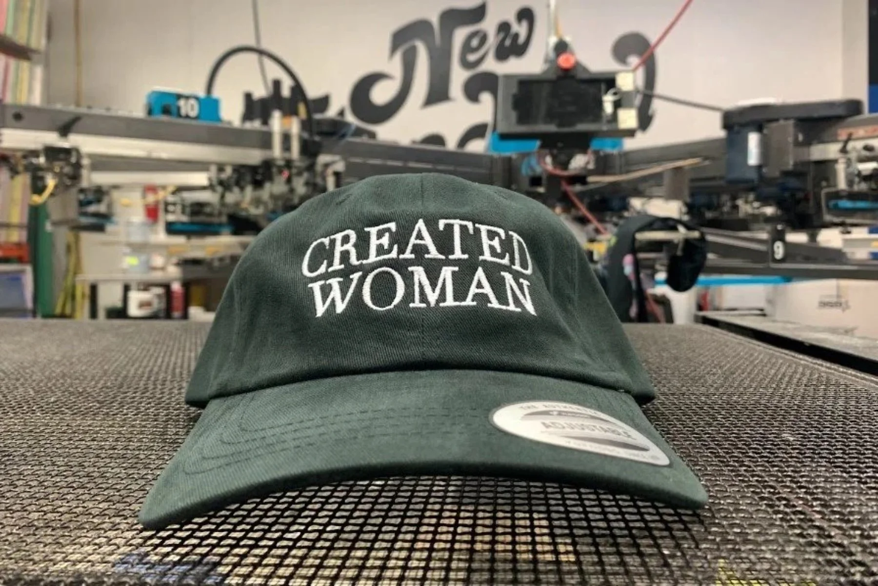 Custom logo embroidery on corporate headwear produced for Created Woman in Austin TX.