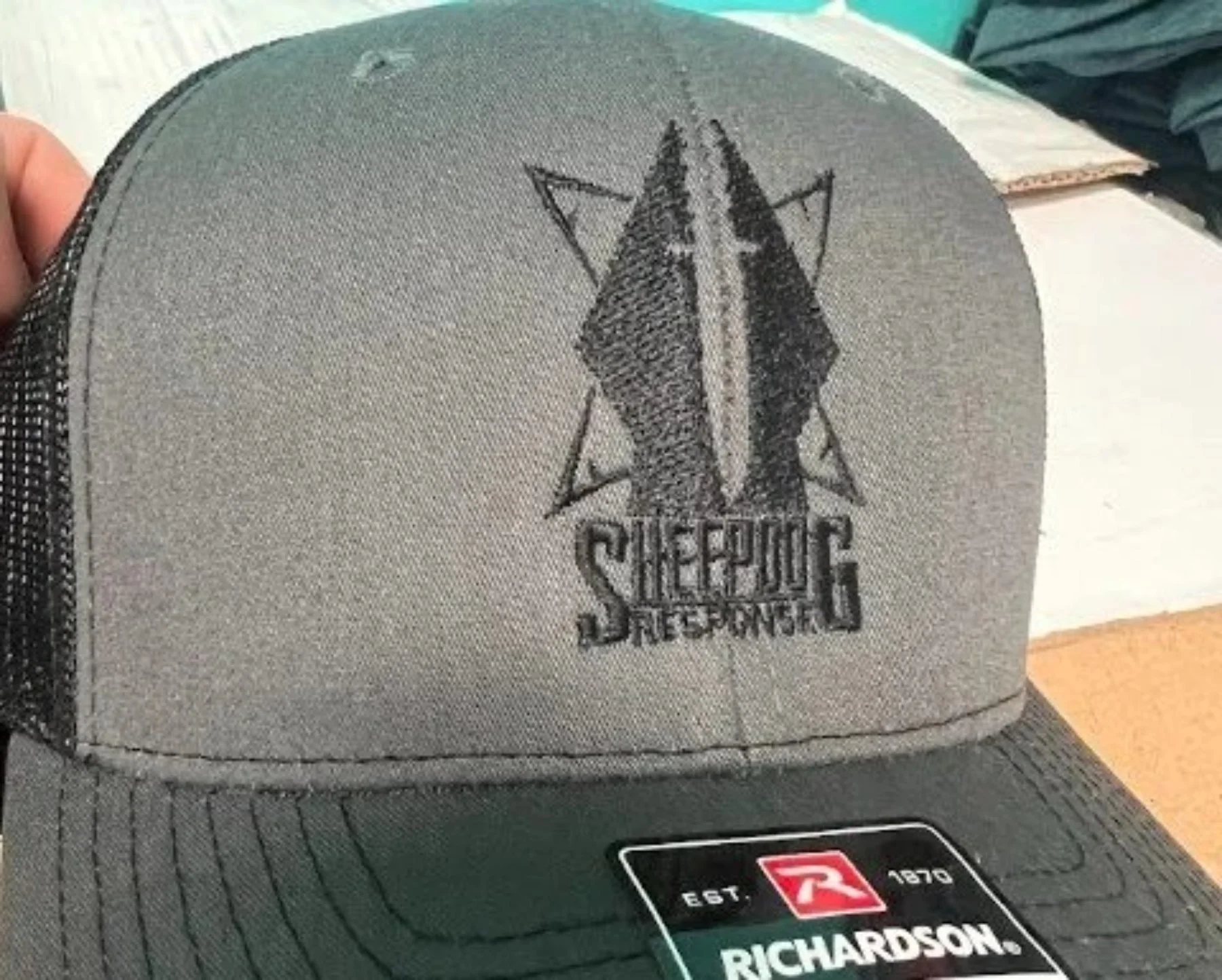 Custom logo embroidery on corporate headwear produced for Sheepdog Response in Austin TX.