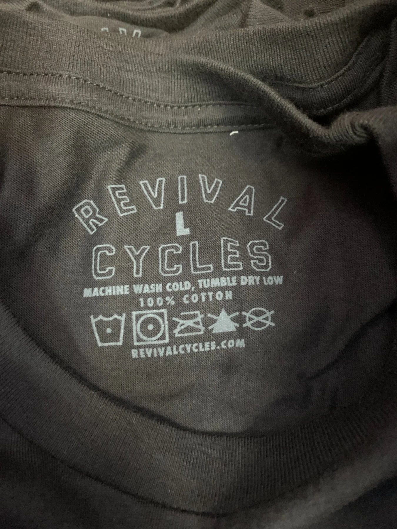 Custom screen printed inside neck tags and retail relabeling produced for Revival Cycles in Austin TX.