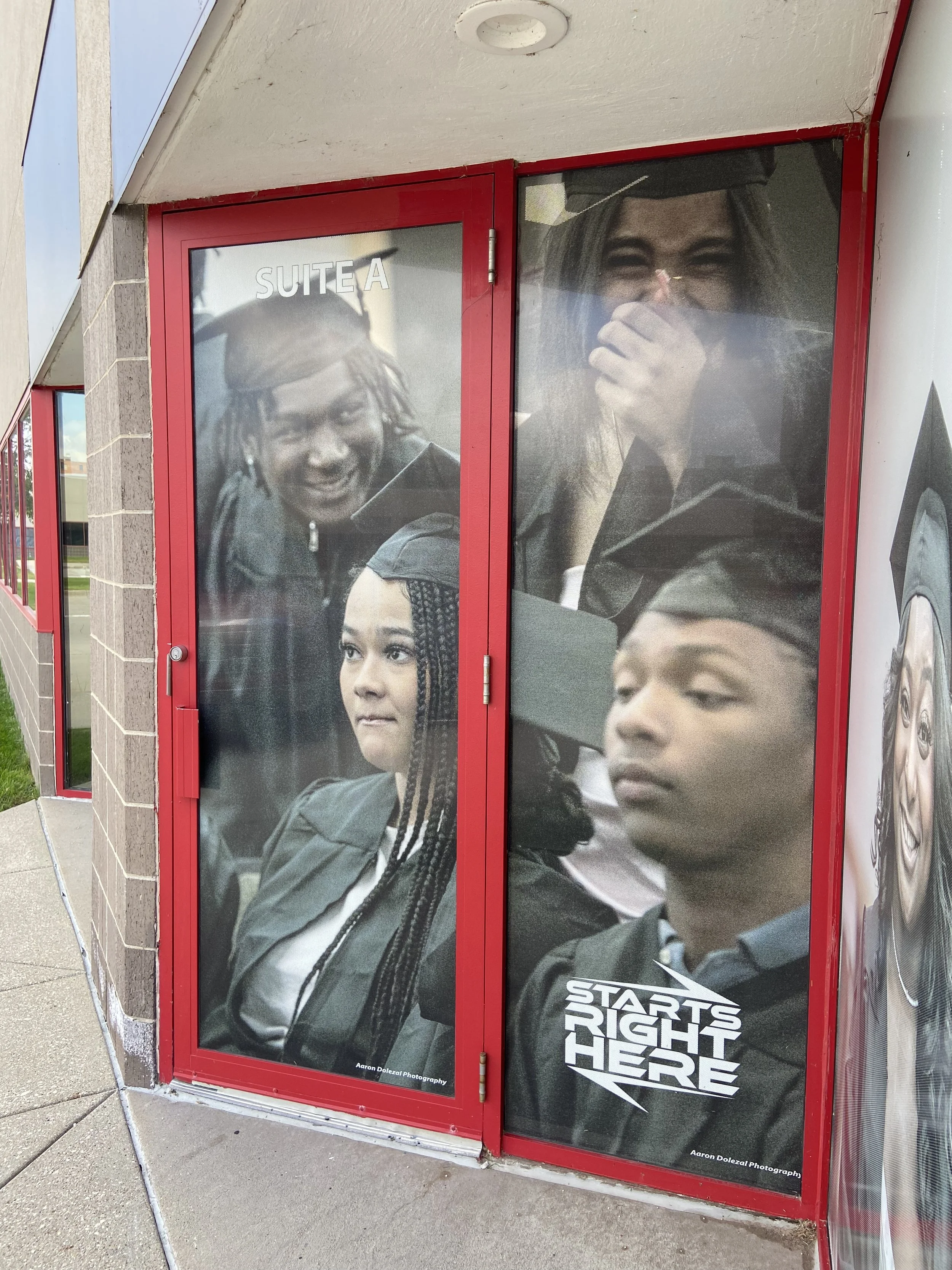 Poster on a red door promoting the video game 'Star Wars: The Right Here' with images of characters from the game and a logo at the bottom.