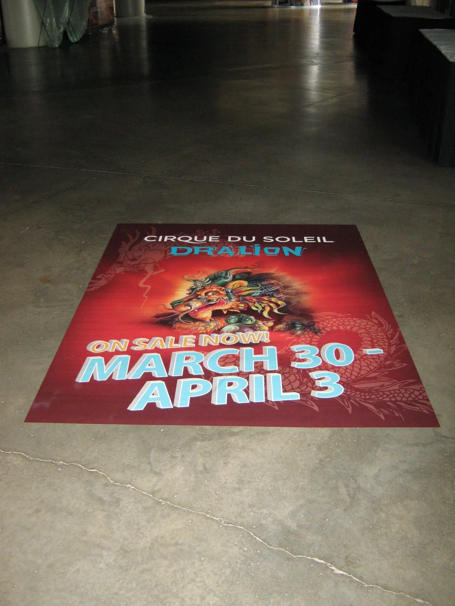 Floor poster advertising Cirque du Soleil's Dragon show, on sale from March 30 to April 3.