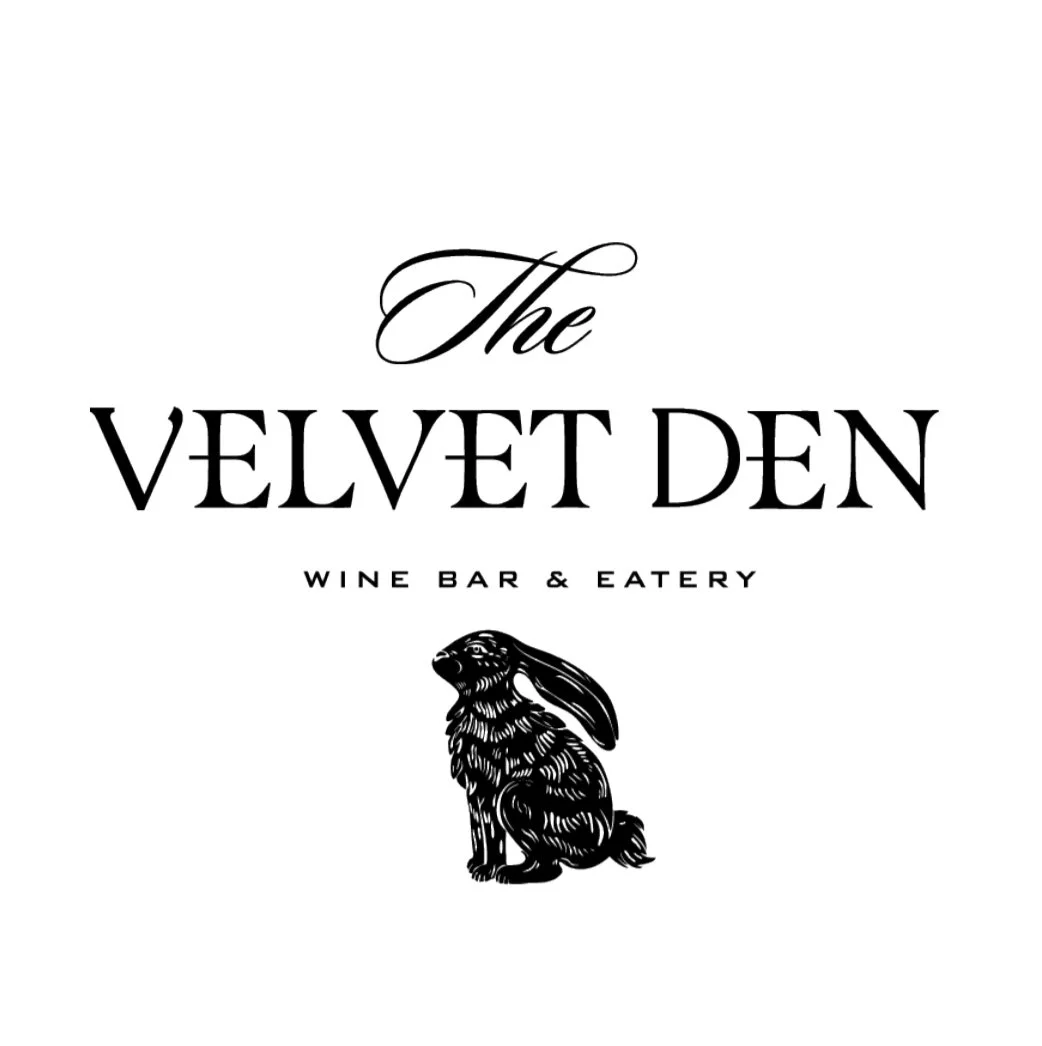 Logo for The Velvet Den, a wine bar and eatery, with a black and white illustration of a rabbit.