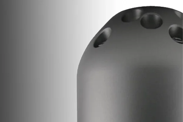 Close-up of a black electronic device with multiple circular holes on its surface.