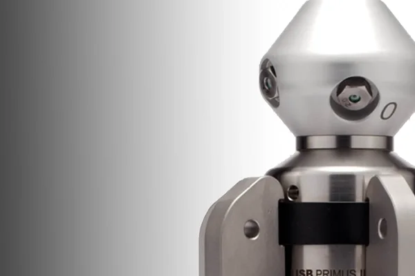 Close-up of a metallic robot with a geometric head and multiple camera lenses for eyes.