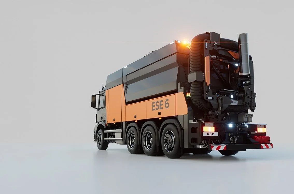A futuristic street sweeper truck with orange and black design, labeled 'ESE 6', parked on a plain white surface