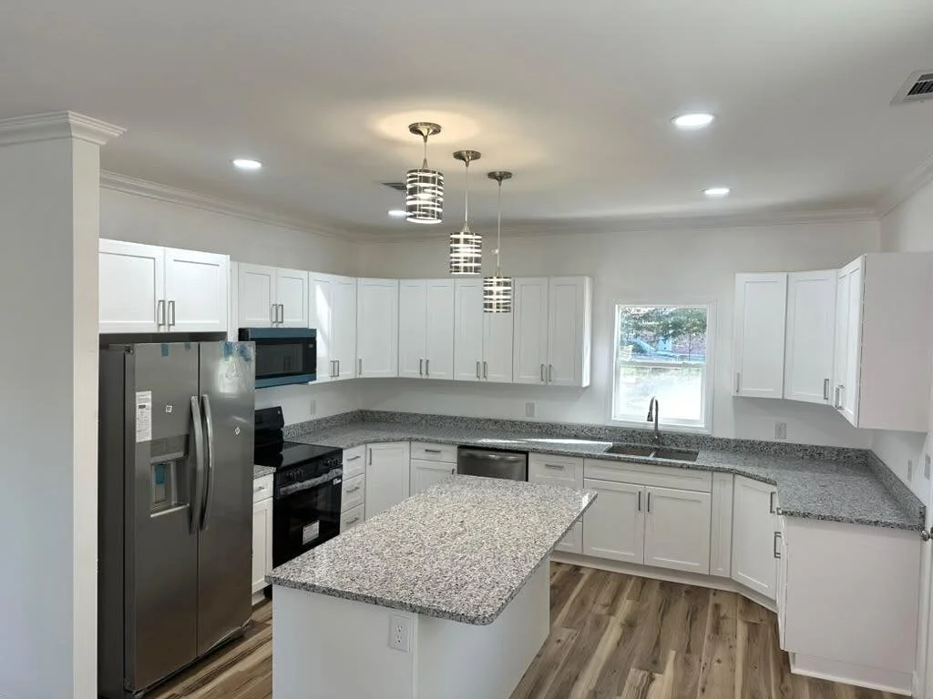 Granite countertops, a custom-designed kitchen with ample cabinet space, and stainless steel appliances.