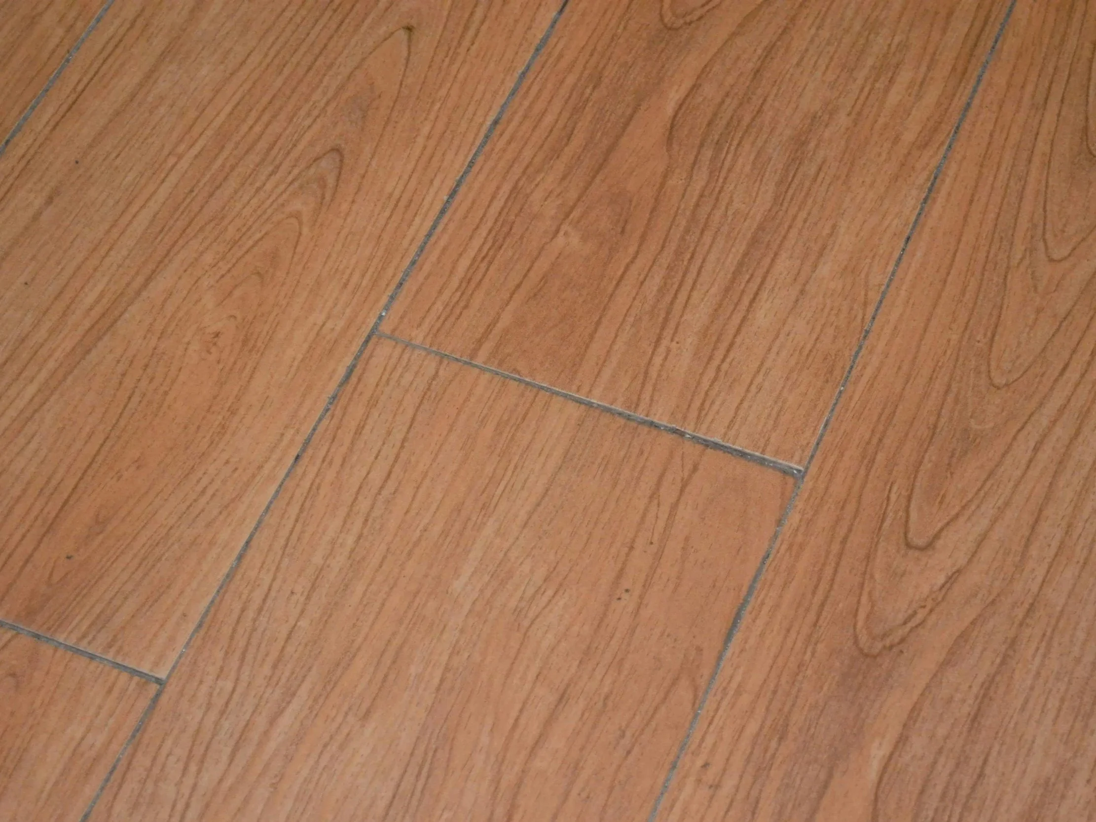 Close-up view of wooden floor tiles with a natural finish and visible grain patterns.